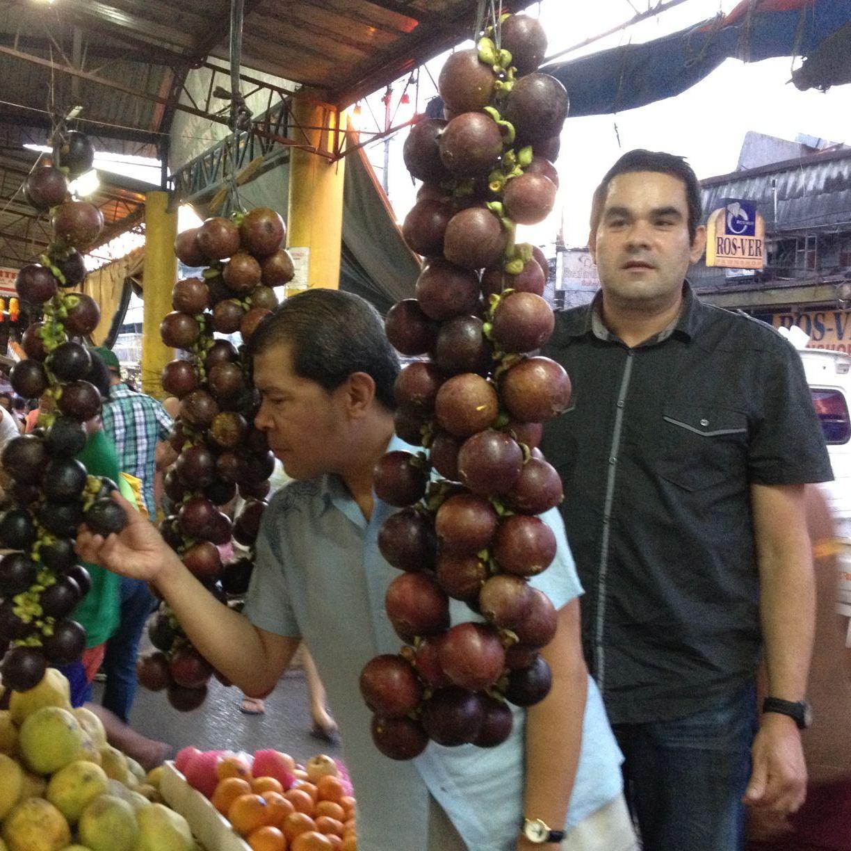 Examining mangosteen fruit in Davao where Michael was born.