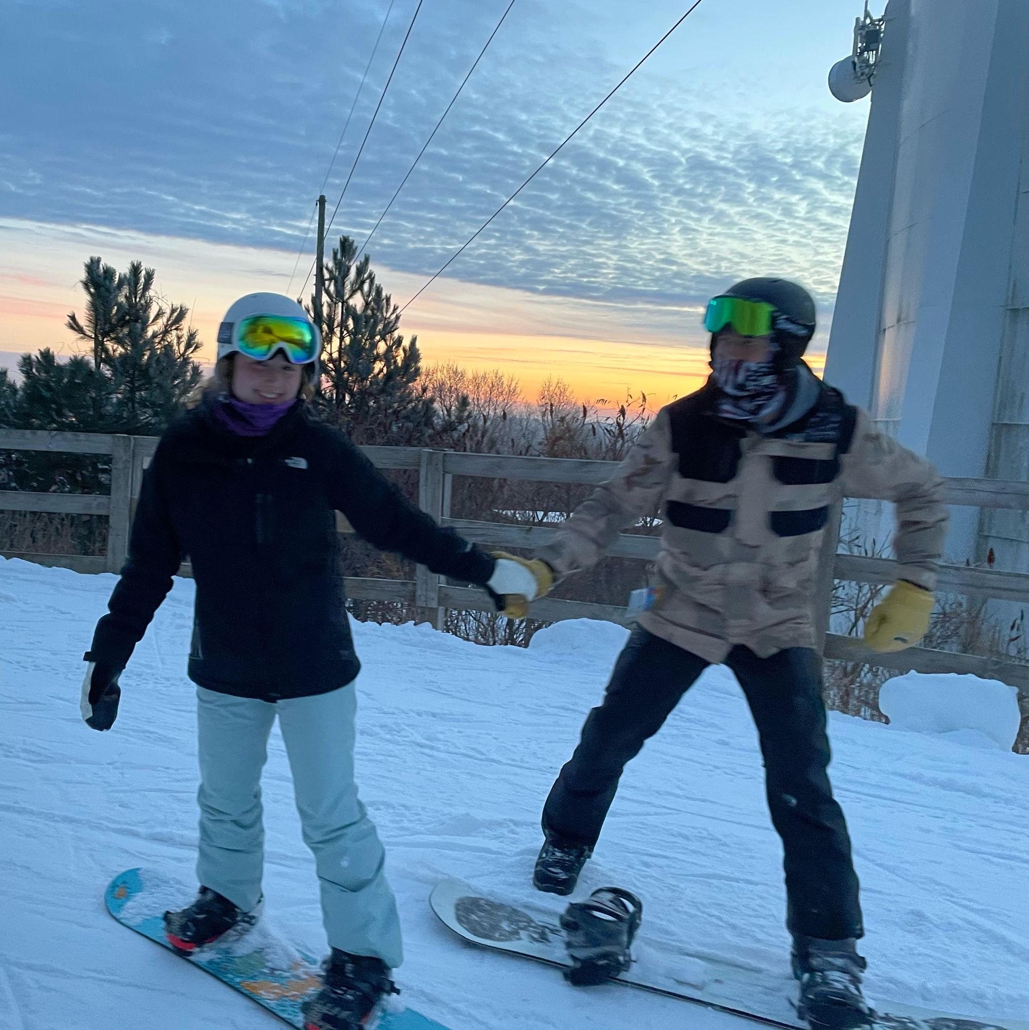 Carter teaching Brynn to snowboard (with a lot of patience)
