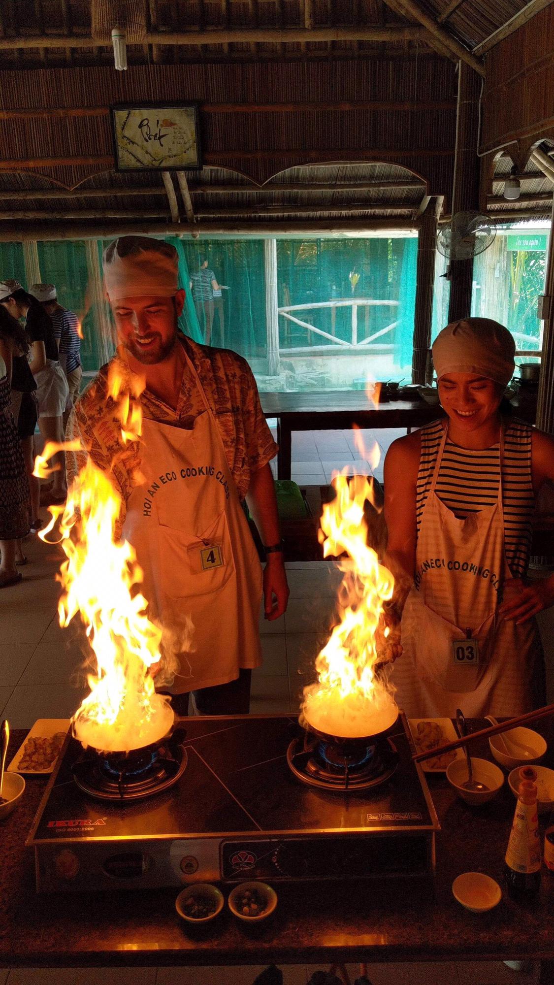 Cooking with fire to make Banh Xeo at our cooking class in Hoi An, Vietnam.