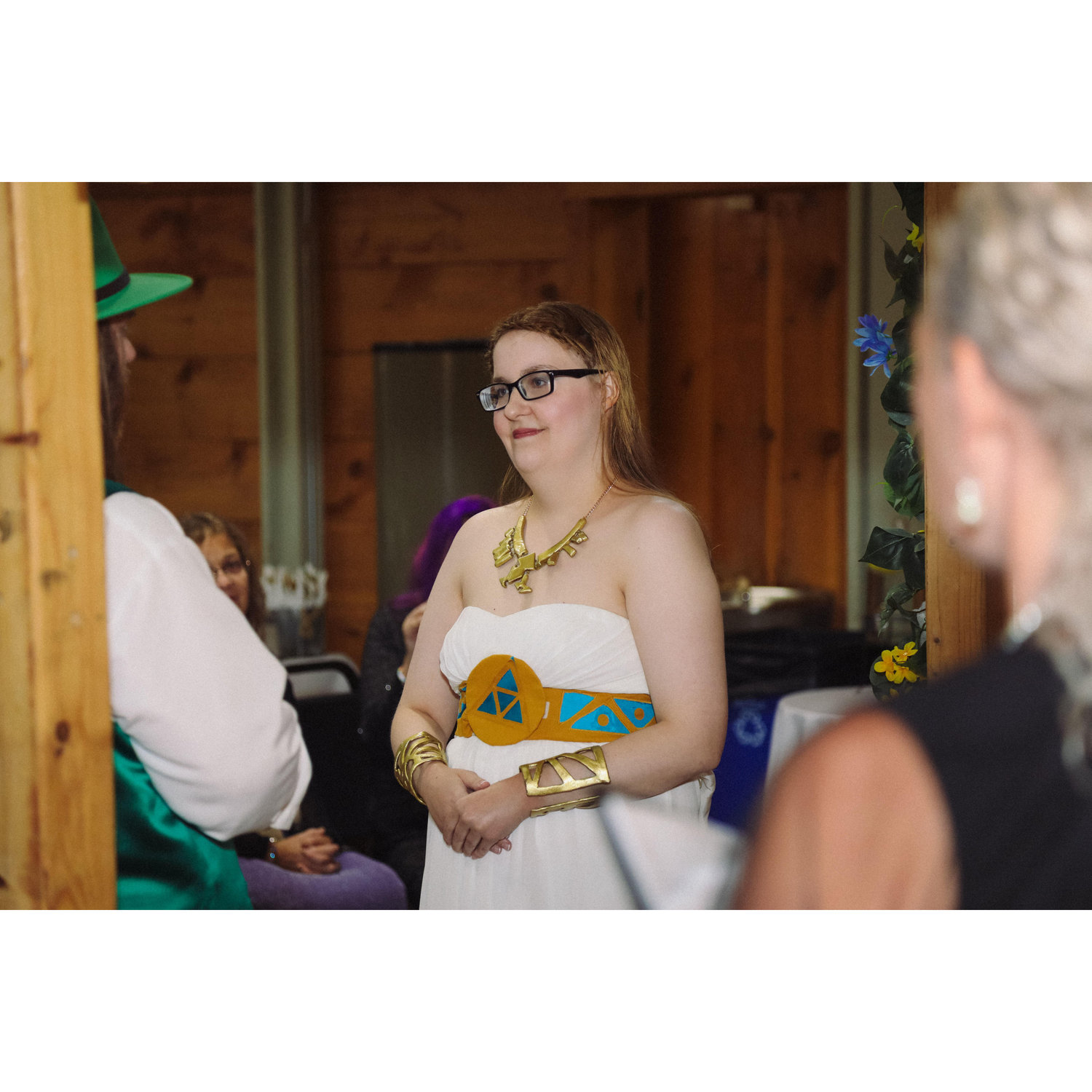 during the ceremony, Sara and Herb under the arch with the officiant vieved from behind Herb