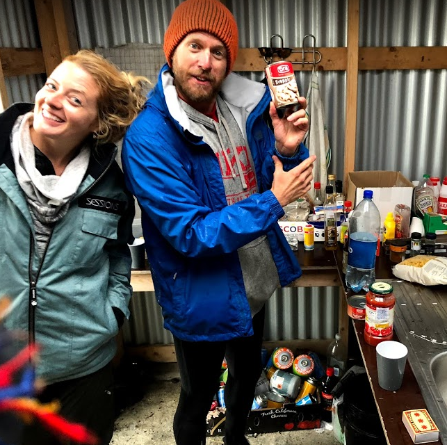 Trying to survive a freezing monsoon in a small camping shack. Please note the tight leggings on Kelly,