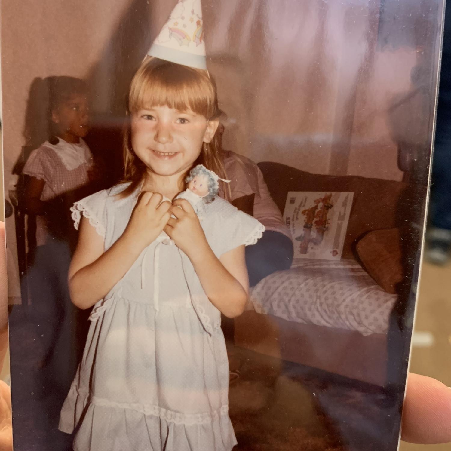 Rocking the full forehead bangs, and loving the blueberry scented doll.