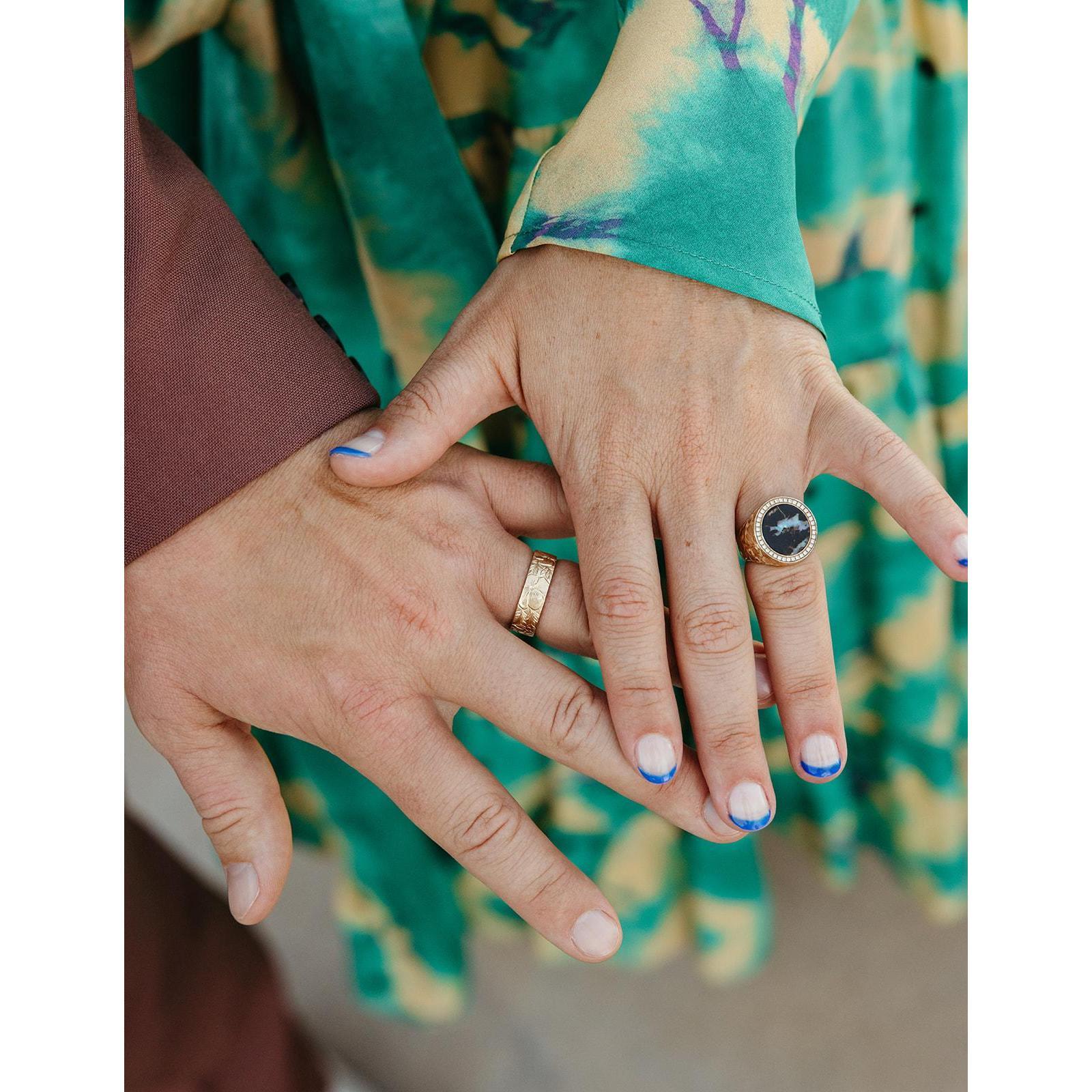 Our custom rings made by Julio Cuellar Jewelry. The matching engraving is of Michigan and California's state flowers: apple blossoms and poppies.