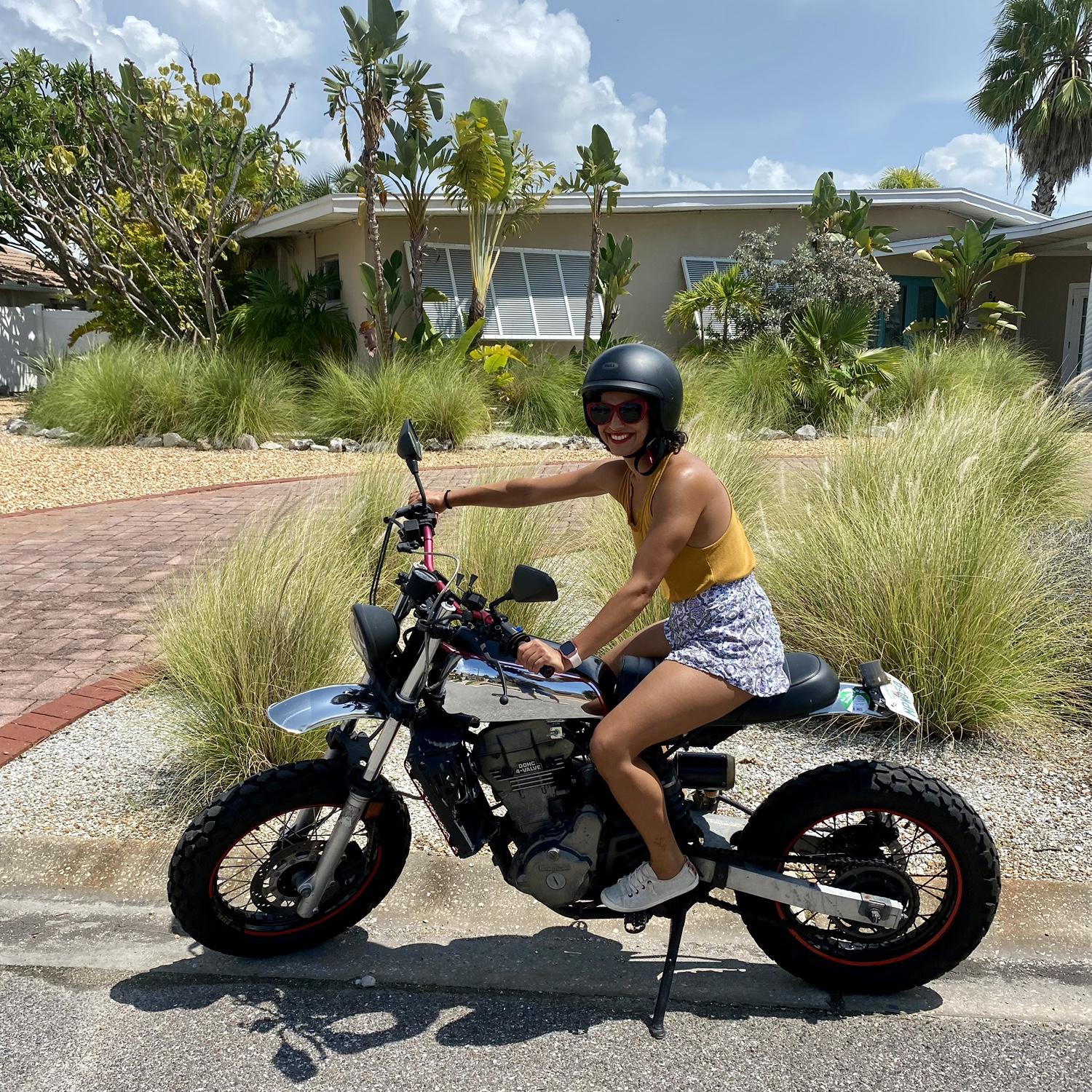 Shabnam pretending to ride Casey’s motorcycle.
