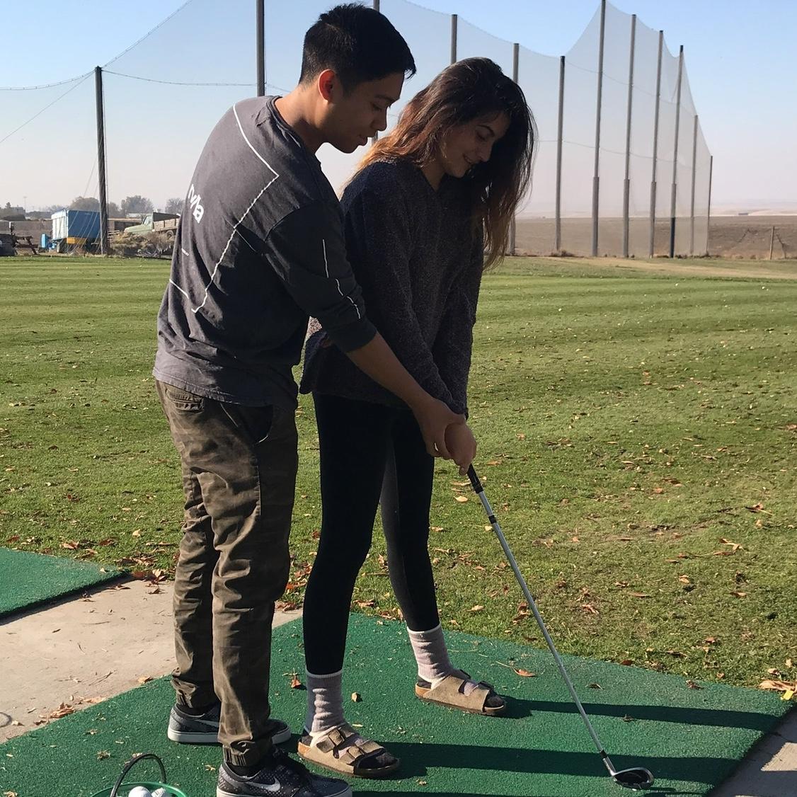 October 2017 - Nolan teaching Vivien Lee how to golf during our freshman year of college in Walla Walla, Washington.