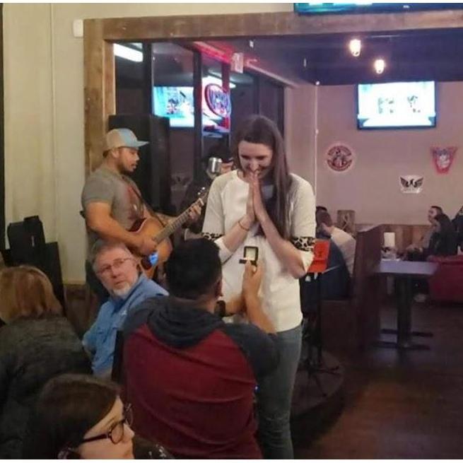 Aaron proposing at Tap & Pour in front of friends :)