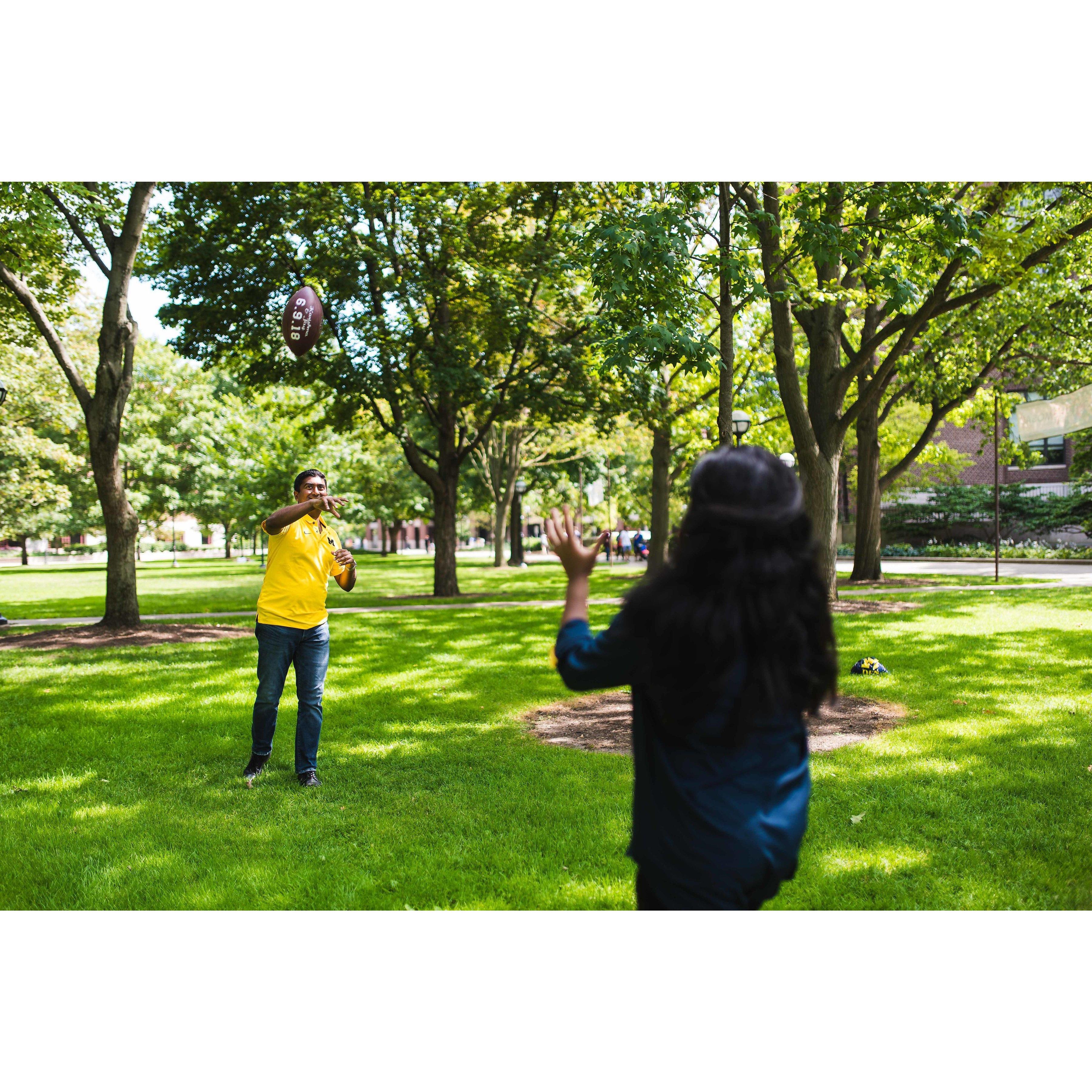 Couple of Kids throwin' the ball at the quad