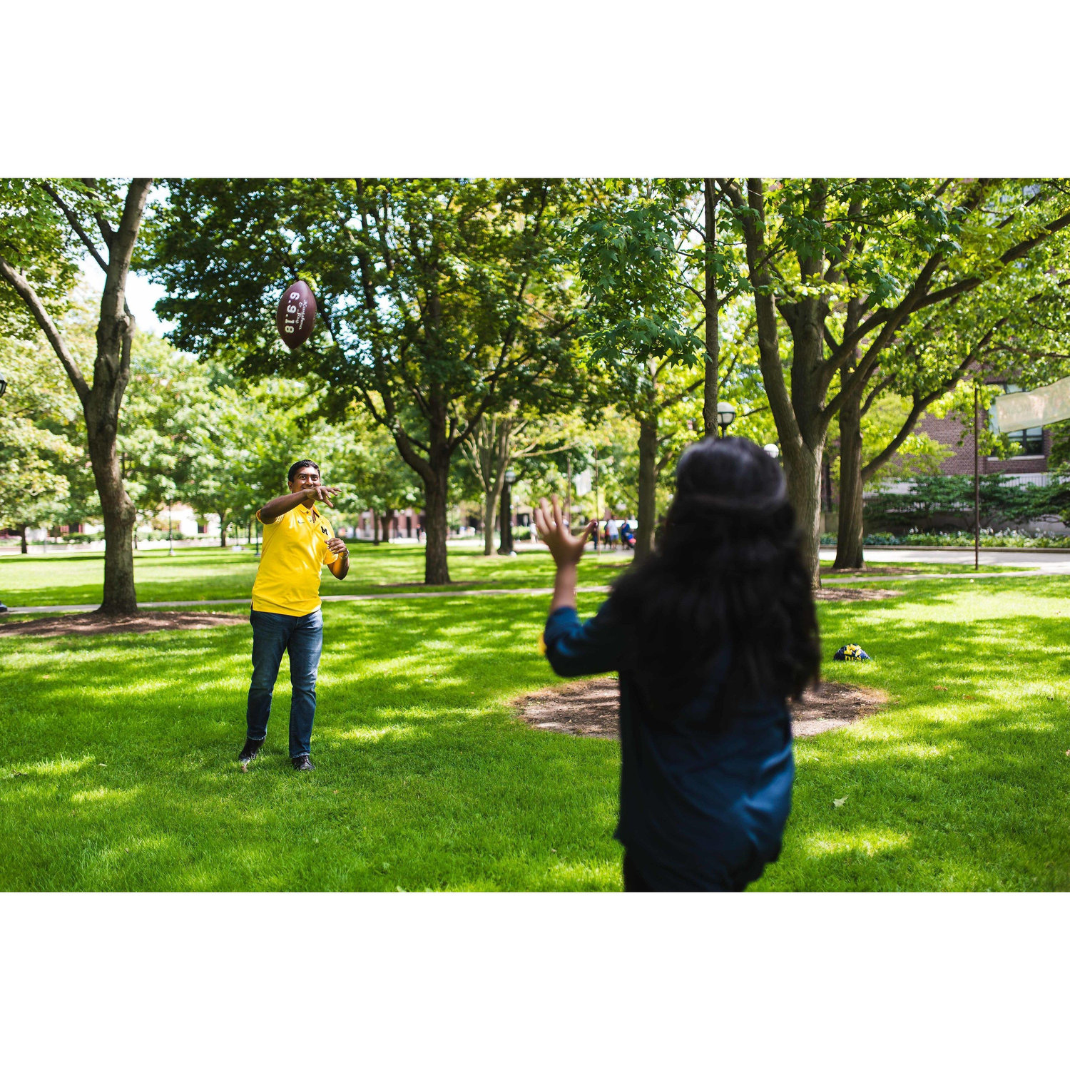 Couple of Kids throwin' the ball at the quad