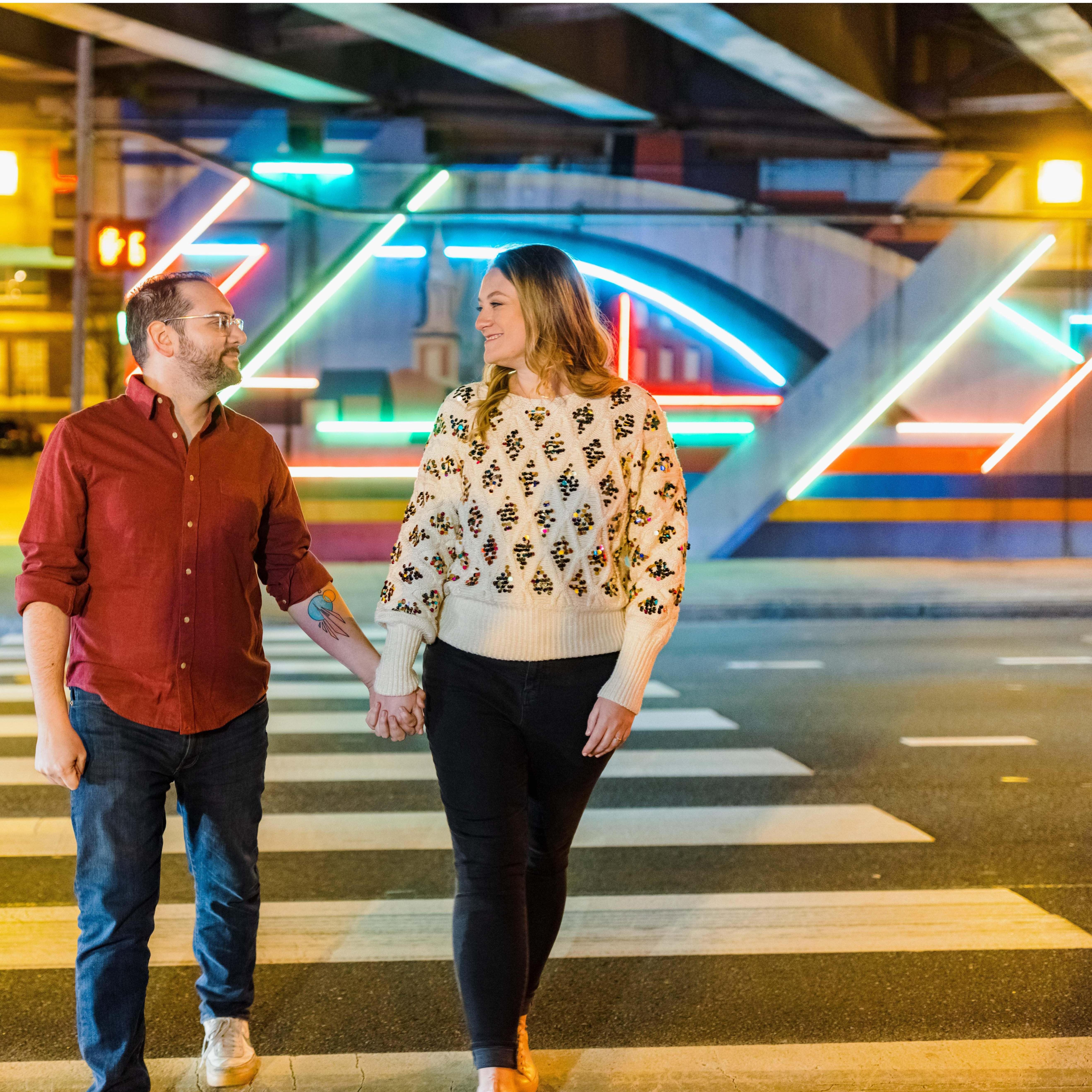 In front of the neon 'Electric Philadelphia' mural in the 6th Street underpass in Philadelphia, PA on February 12, 2022.