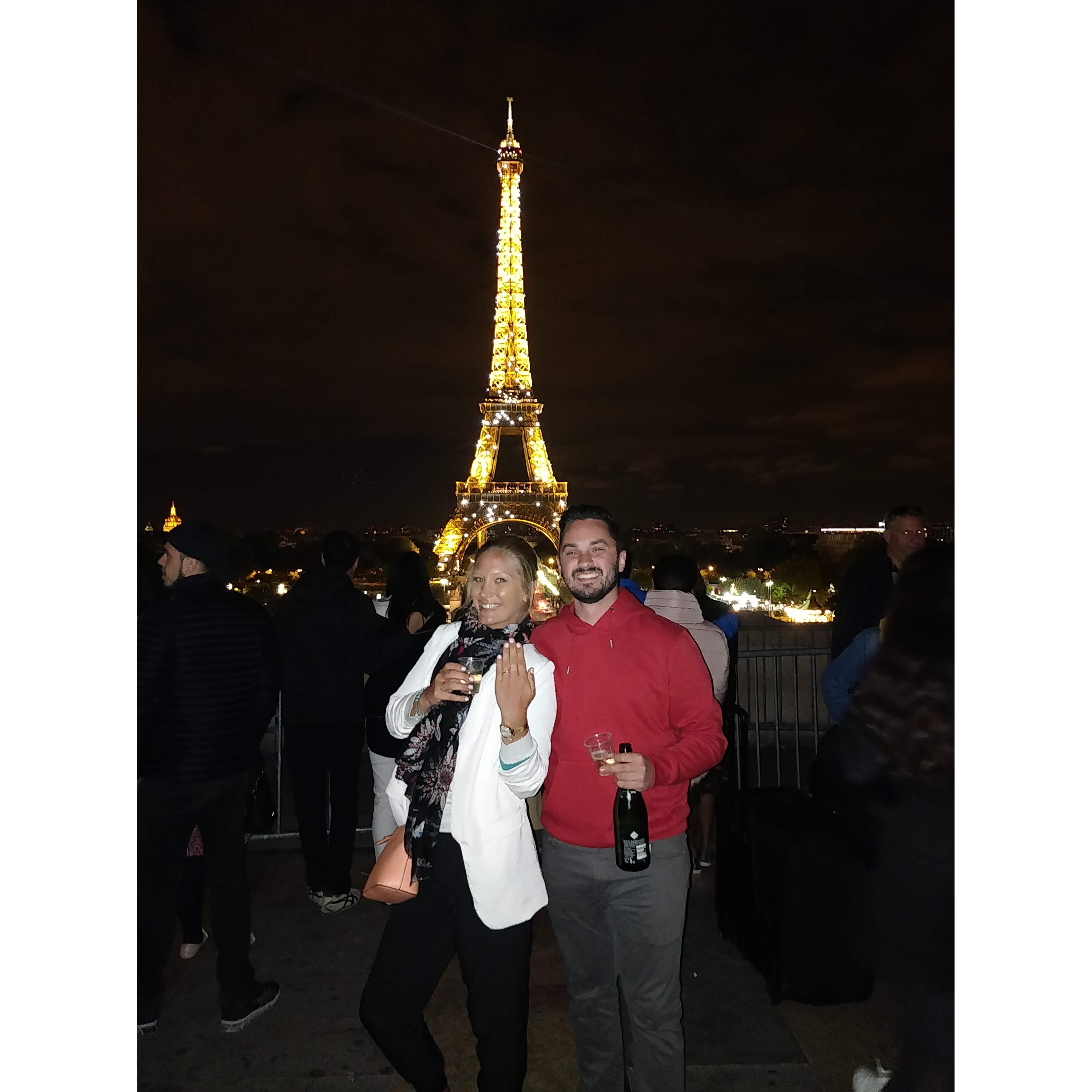 Celebrating our engagement with a glass of bubbly in Paris!