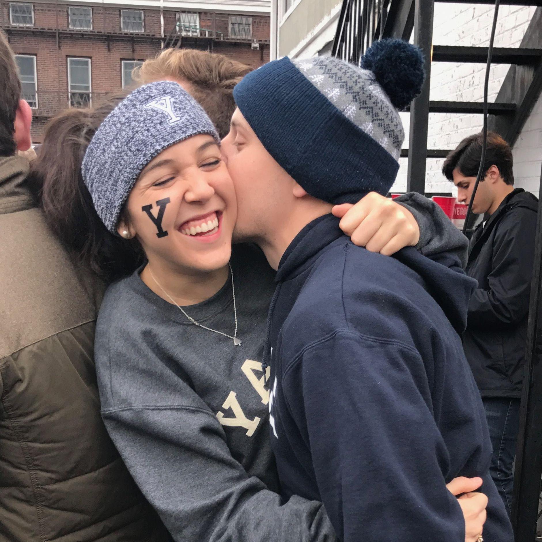 Harvard-Yale, 2017. The spade necklace was an anniversary gift from John, as a nod to their shared love of card games. AG still wears it every day.