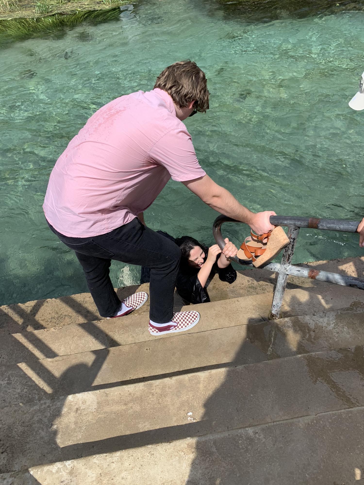 TXST graduation tradition is to jump into the river in your graduation gown and clothes. I didn't realize how heavy it was and could not get out. It took Dane and my giant brother to get me out.