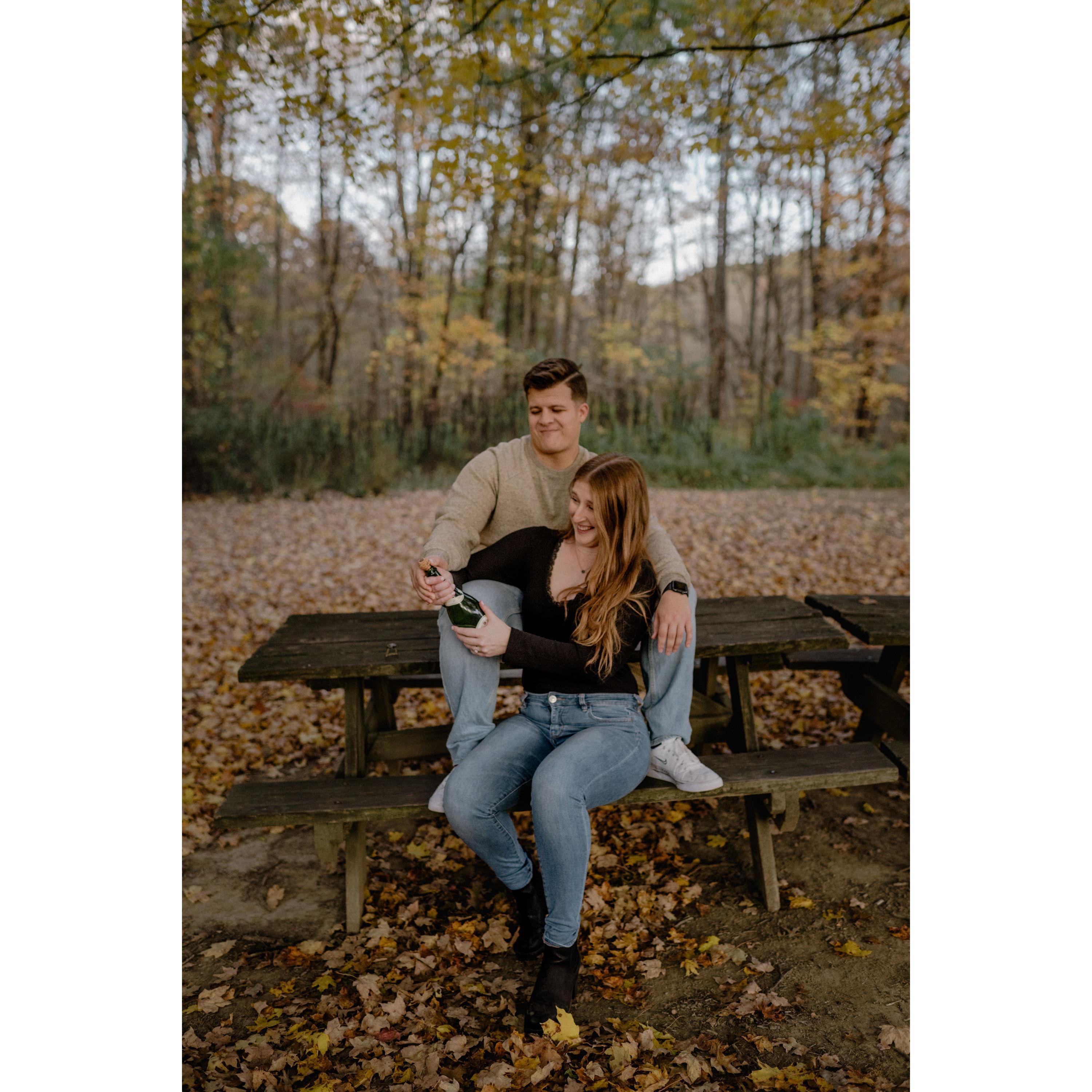 Popping the champagne to celebrate our engagement!