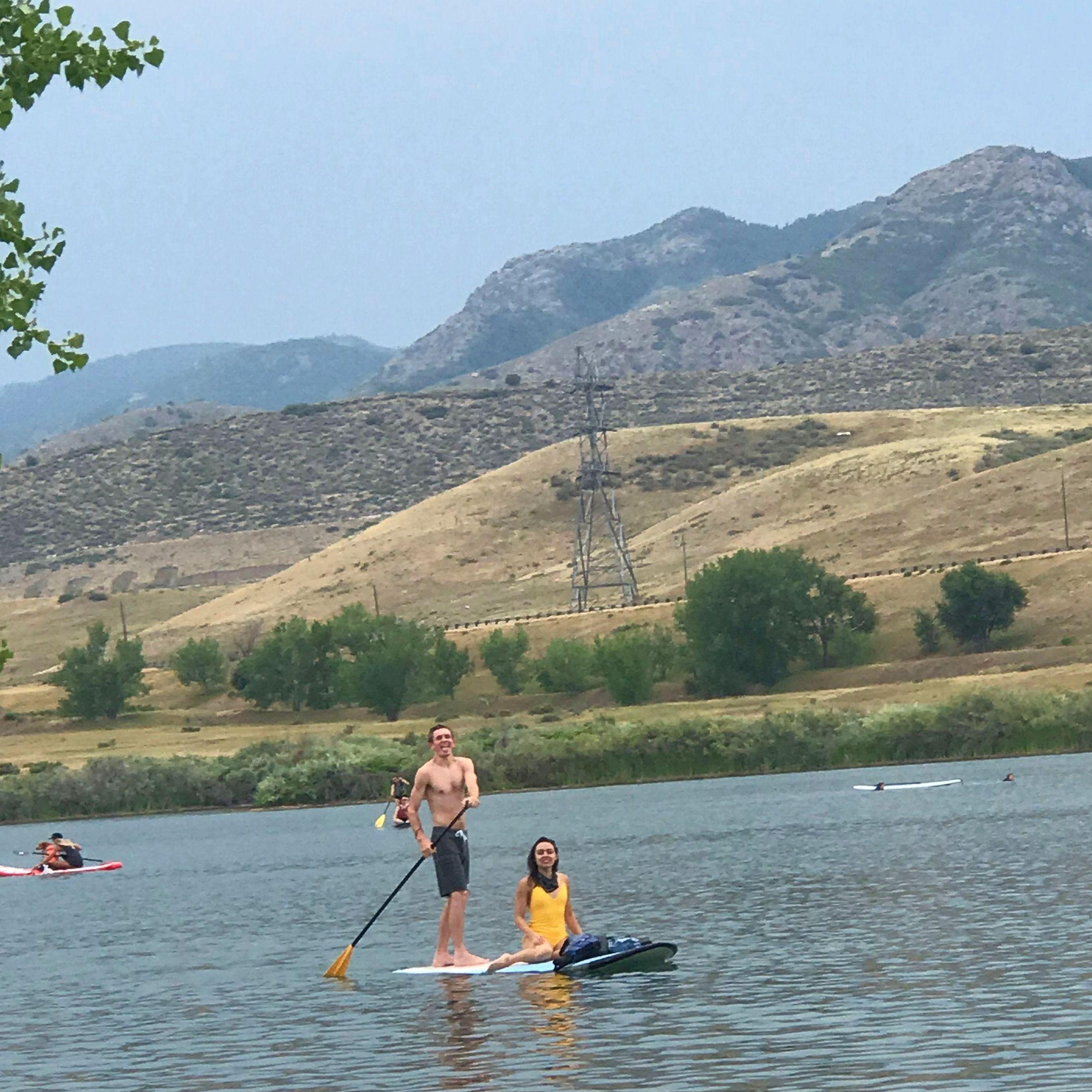 One of our first dates, paddle boarding, lake, and dogs!