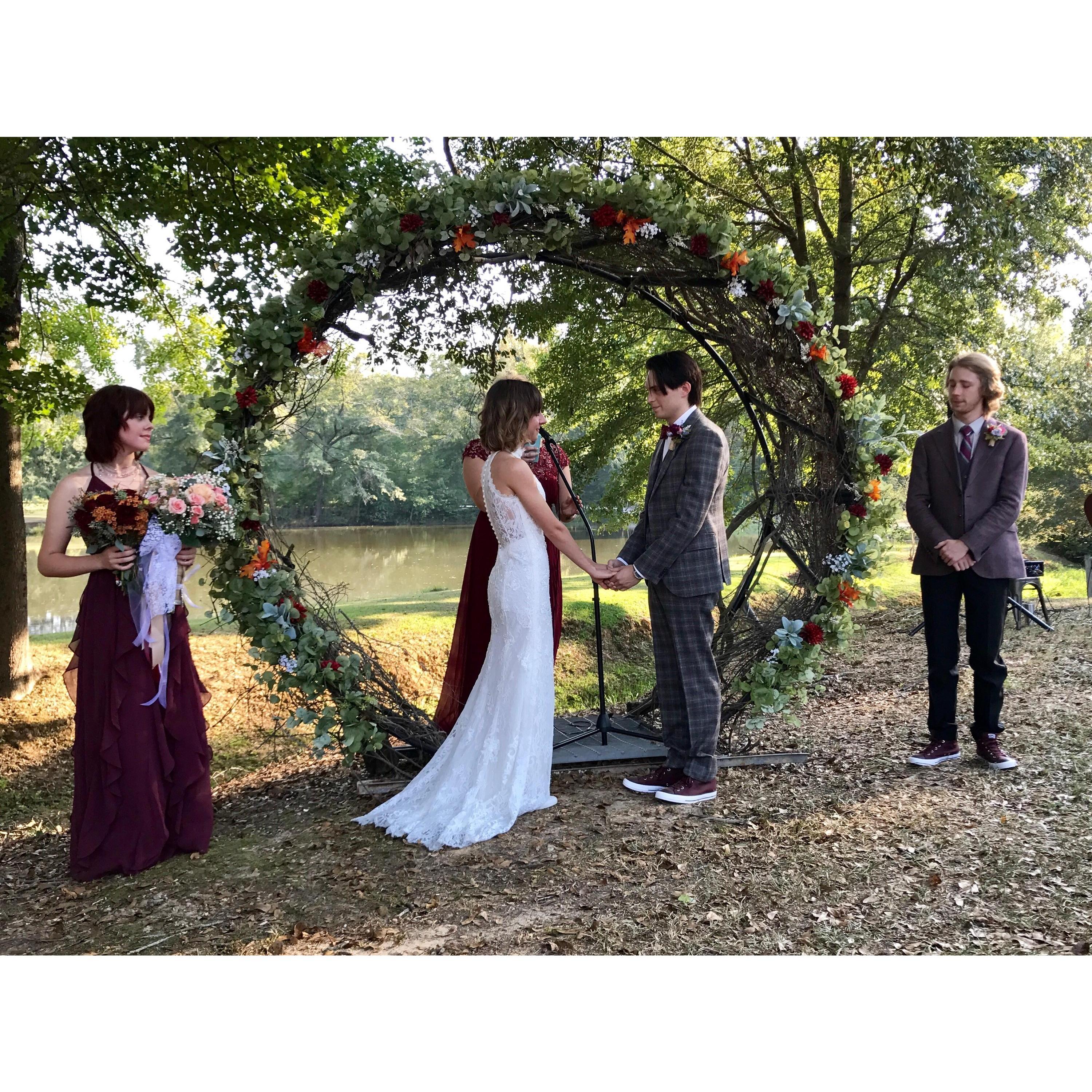 Allisyn and Dylan exchanging vows and rings at their Alabama ceremony.