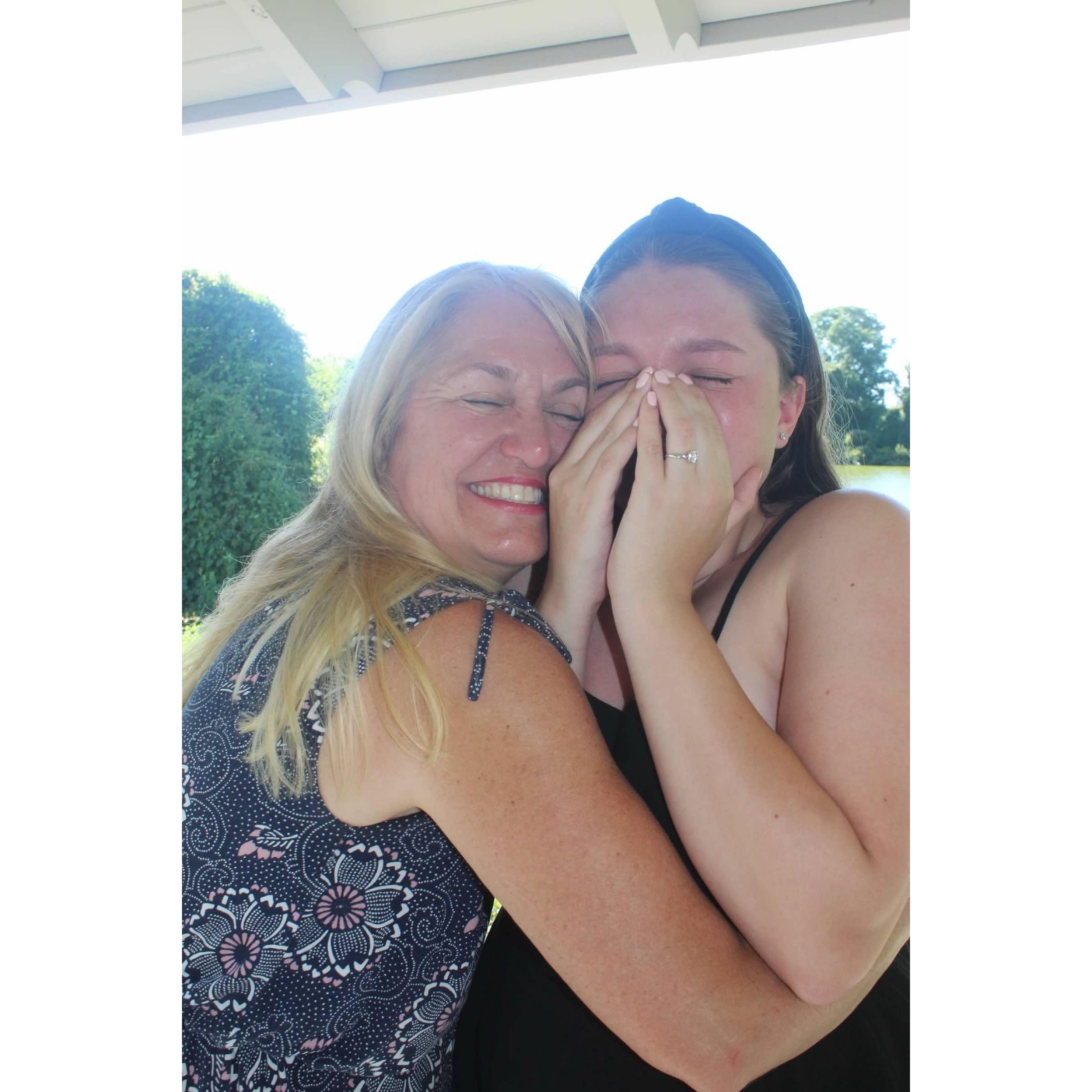 Myla's mom hugging her, while she cries tears of joy.