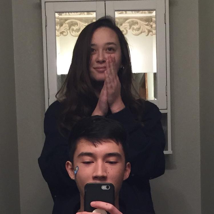 Our first photo together! Sophia giving Kyle the worst haircut he’s ever had. Some believe that this haircut led him to now keep his head shaved.