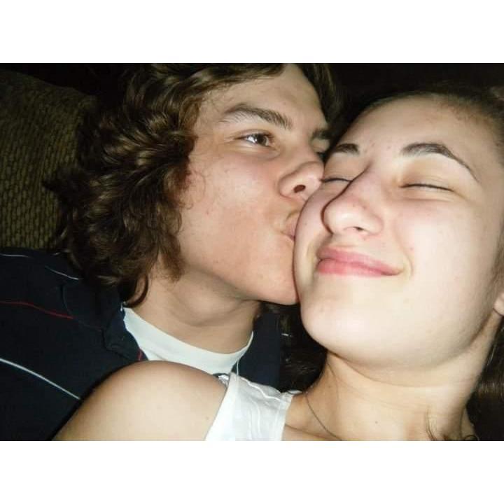 Sneaking kisses on the couch, March 2011.