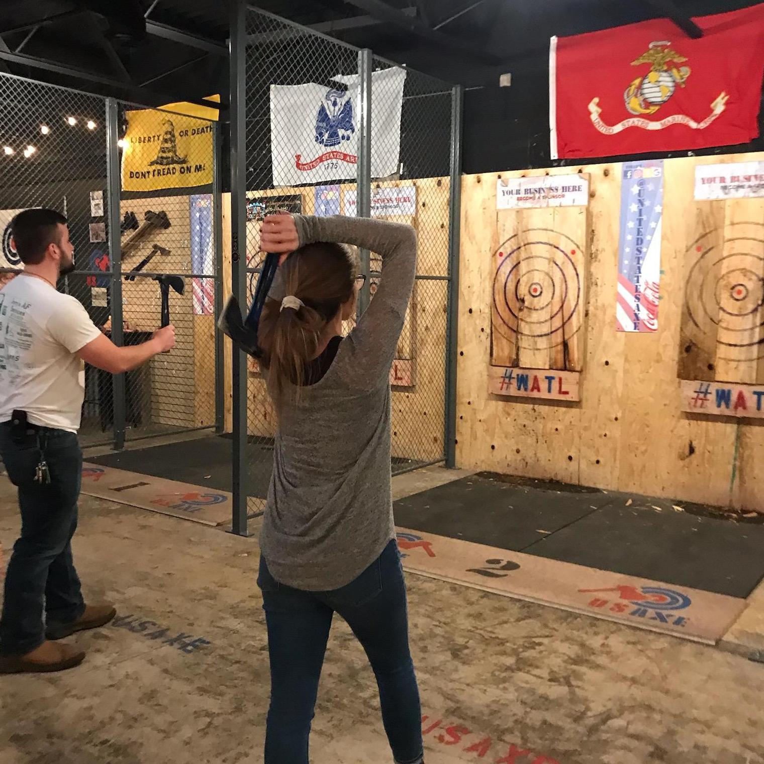 Nancy kicking Zach's butt axe throwing