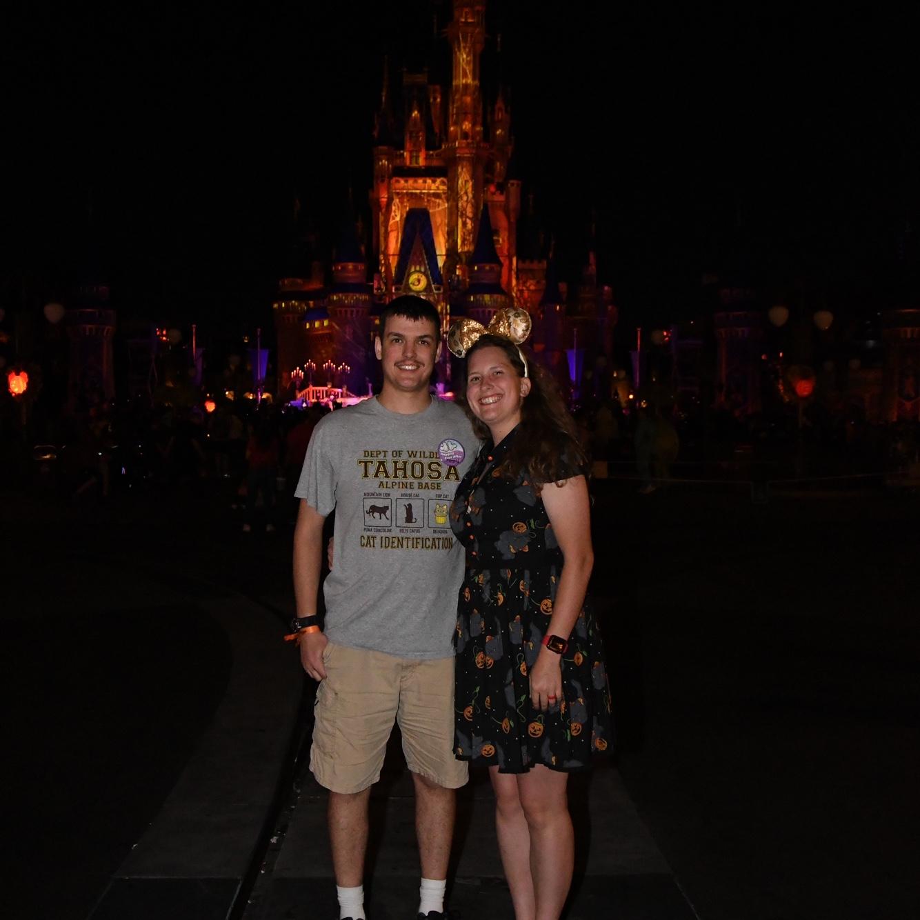 Us in front of the Cinderella Castle in Disney World, Orlando to celebrate getting engaged. We went during the 2023 Not So Scary Halloween Party.