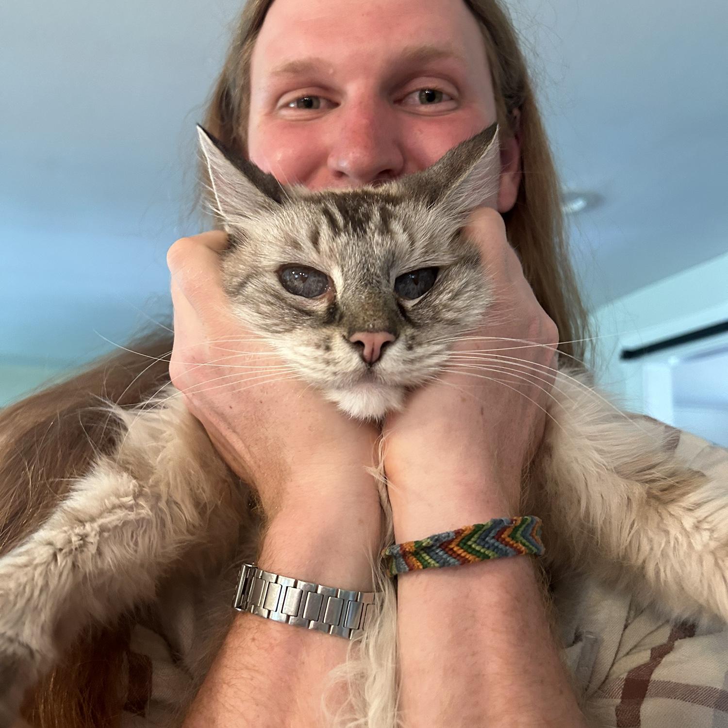 Kyle likes to hold the cats in all manner of strange ways…