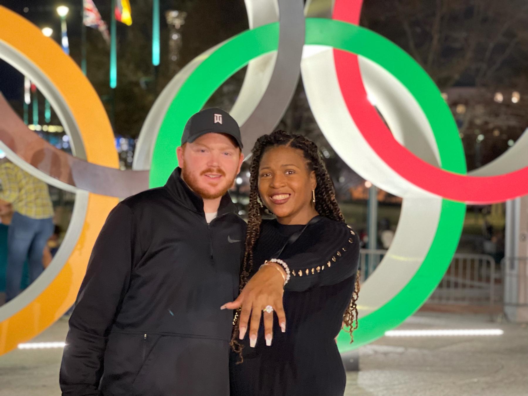 Celebrating our Engagement in the ATL! Olympic Rings in background!