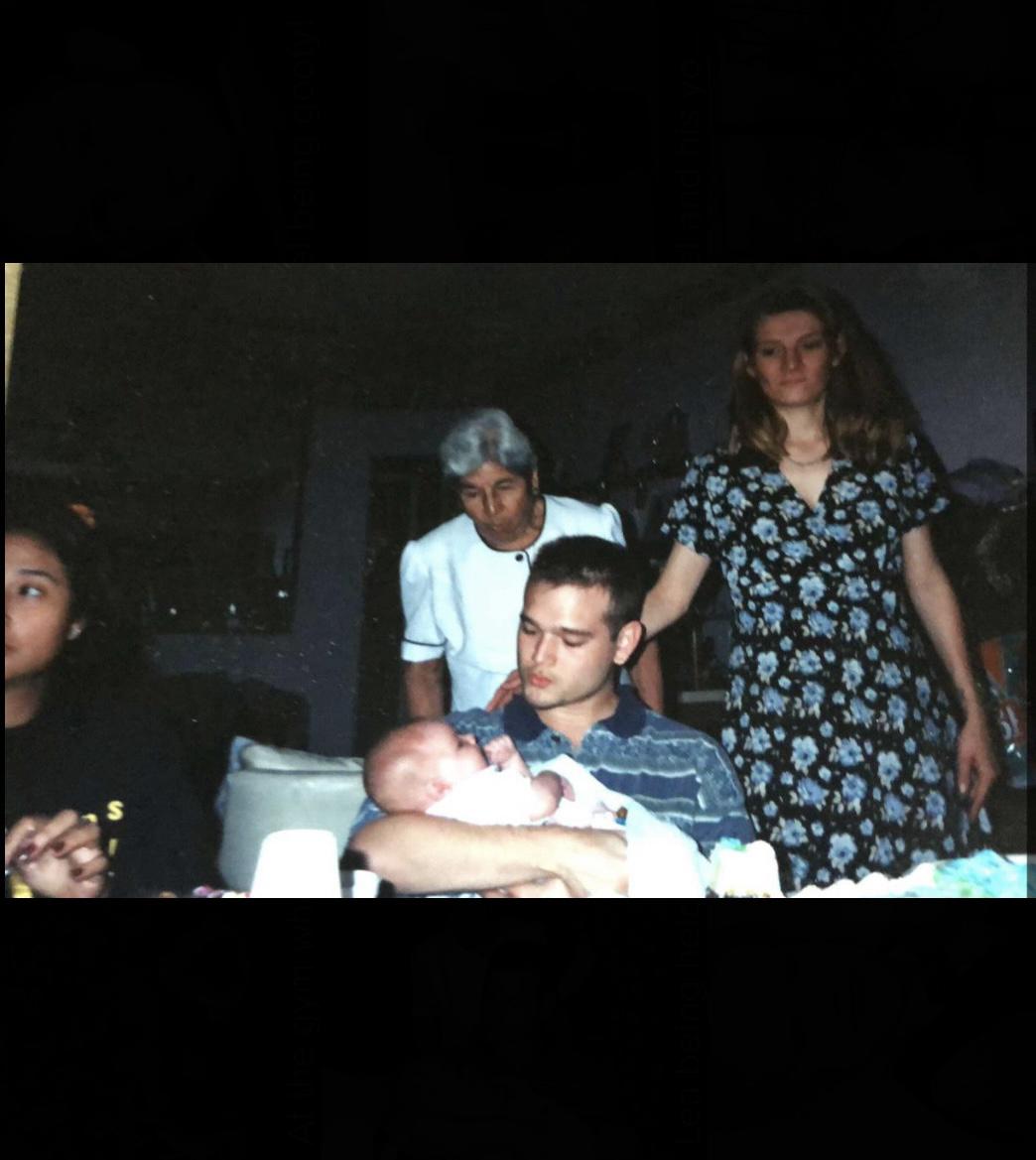 Lea being held by her Uncle with her mom, godmother and great grandmother in her presence