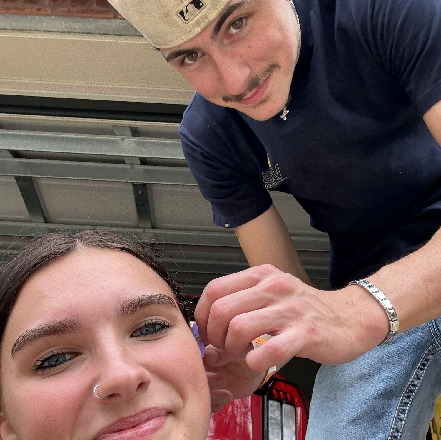Ryan putting a flower in Emma's hair