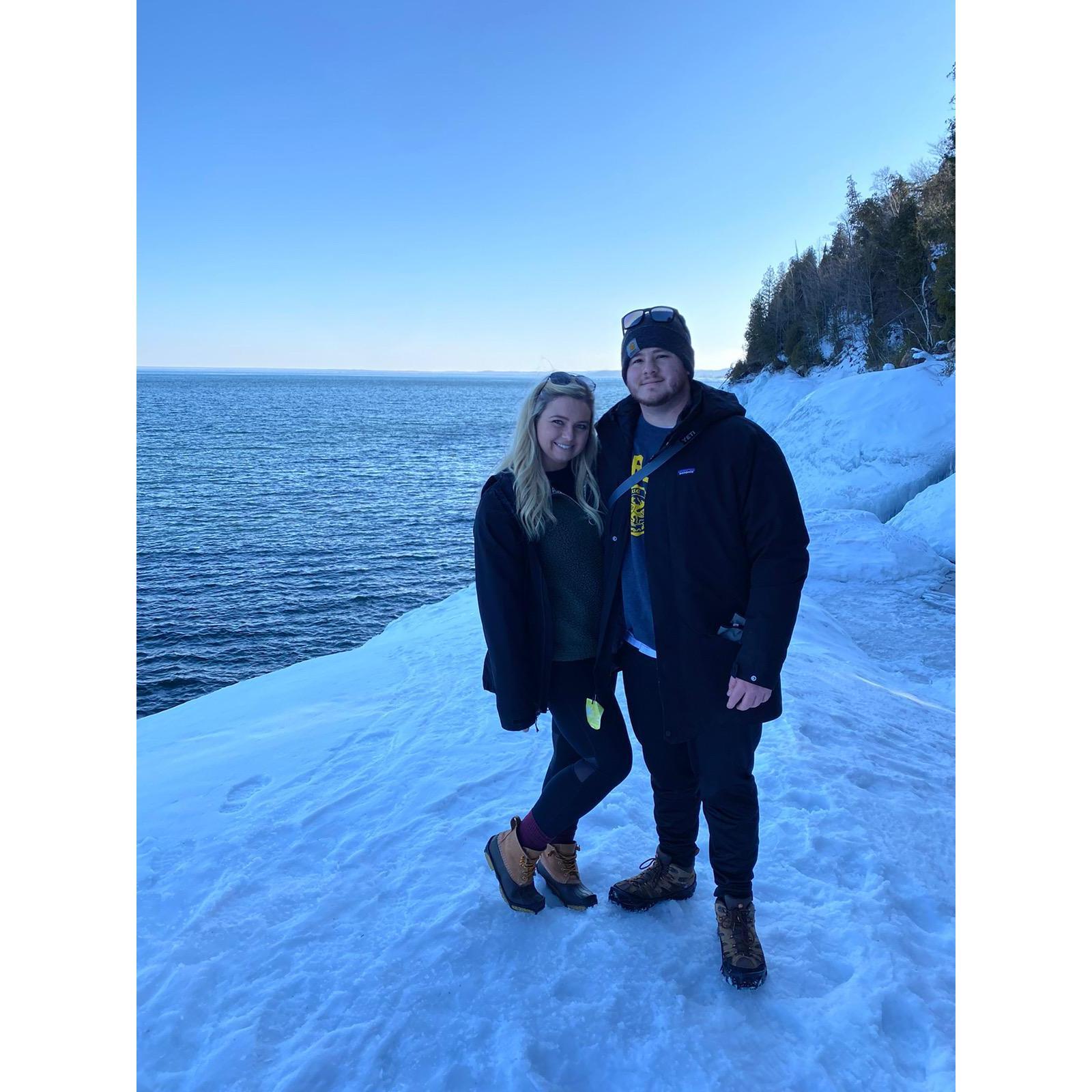 Hiking the iced over black rocks at Presque Isle Park in Marquette, MI.