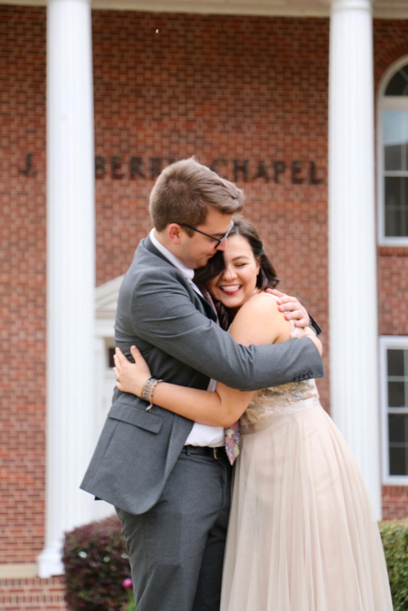 mattie mae and ryan posing in front of the chapel where they will get married this december.