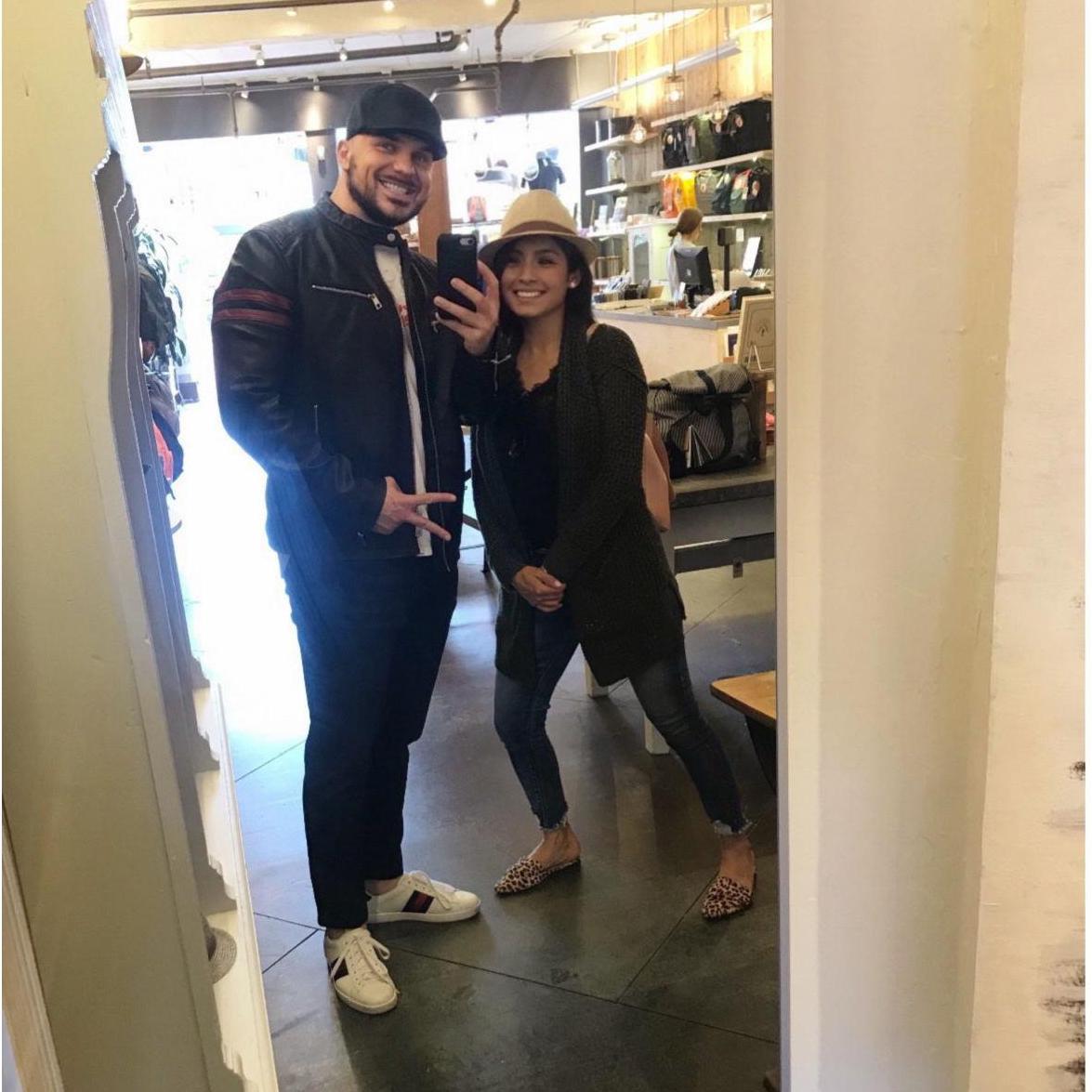 Our first picture together!  On our second date, having some fun in a clothing store and trying on some hats :)