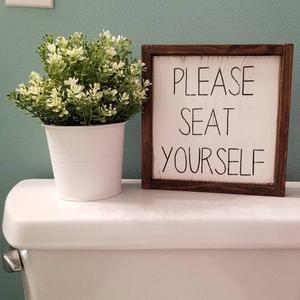 "Please seat yourself" bathroom sign