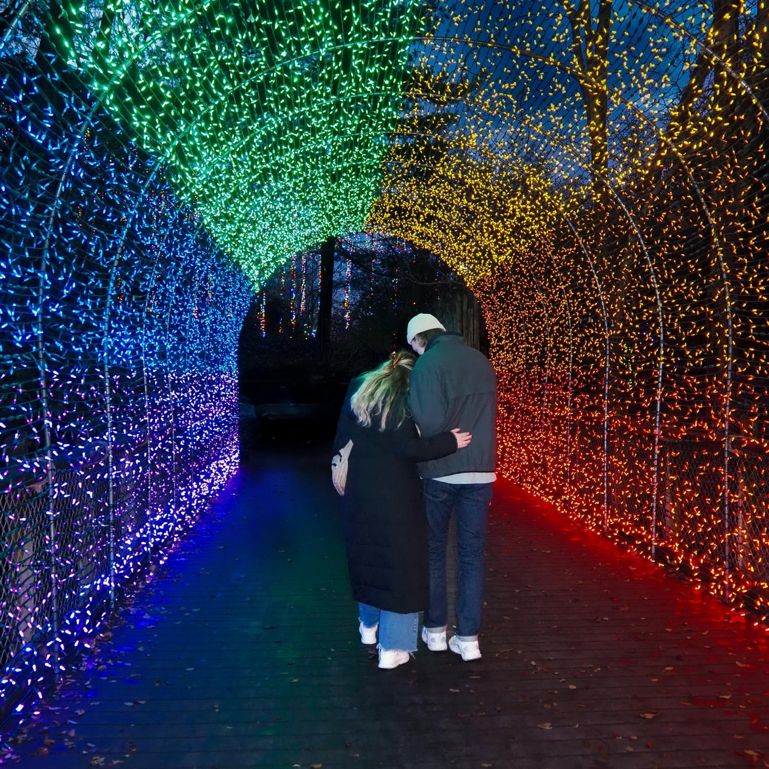 Us right before the proposal in the rainbow light tunnel!