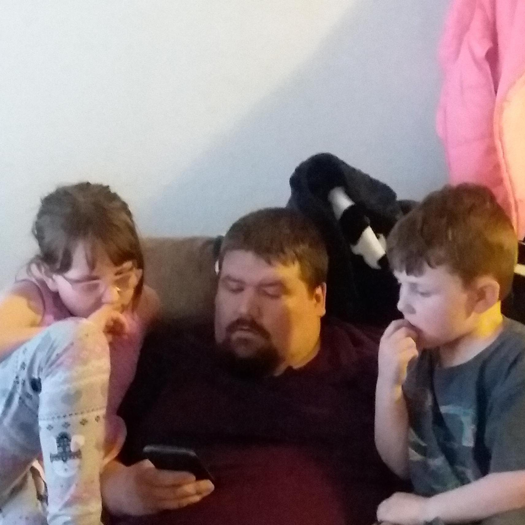 Troy and the kids were watching a video together.