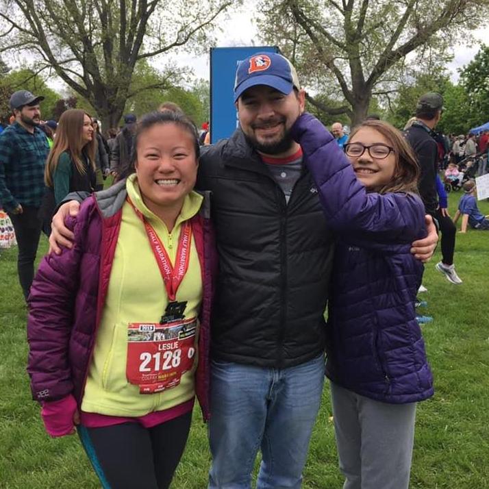 Mike and Peyon meeting Leslie at the finish line of the Colfax half marathon.