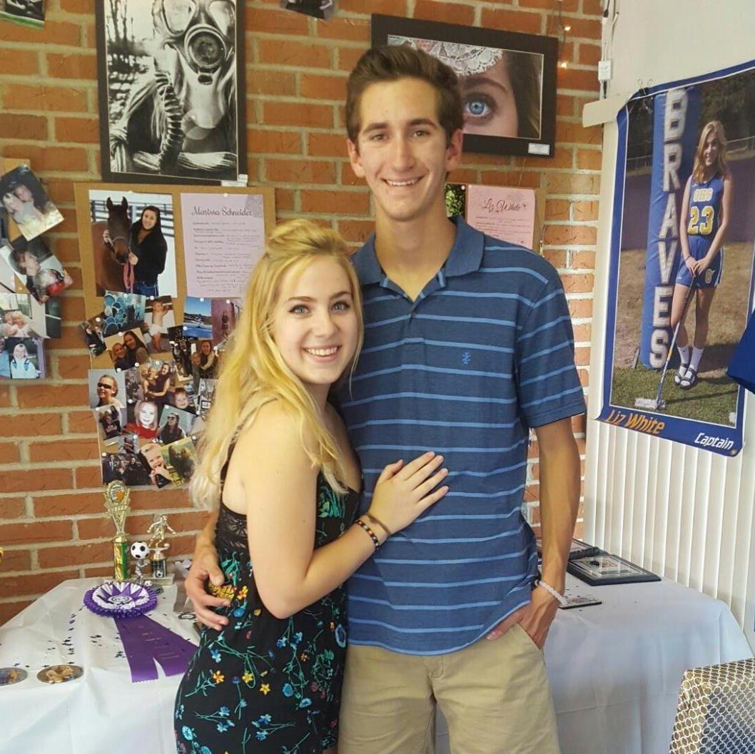 Posing next to her shrine at Liz's graduation party in 2016. Matt prayed to this every night for two weeks before he proposed.