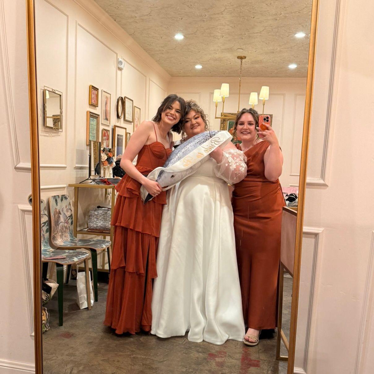 Bride and her girls holding the celebratory salmon
