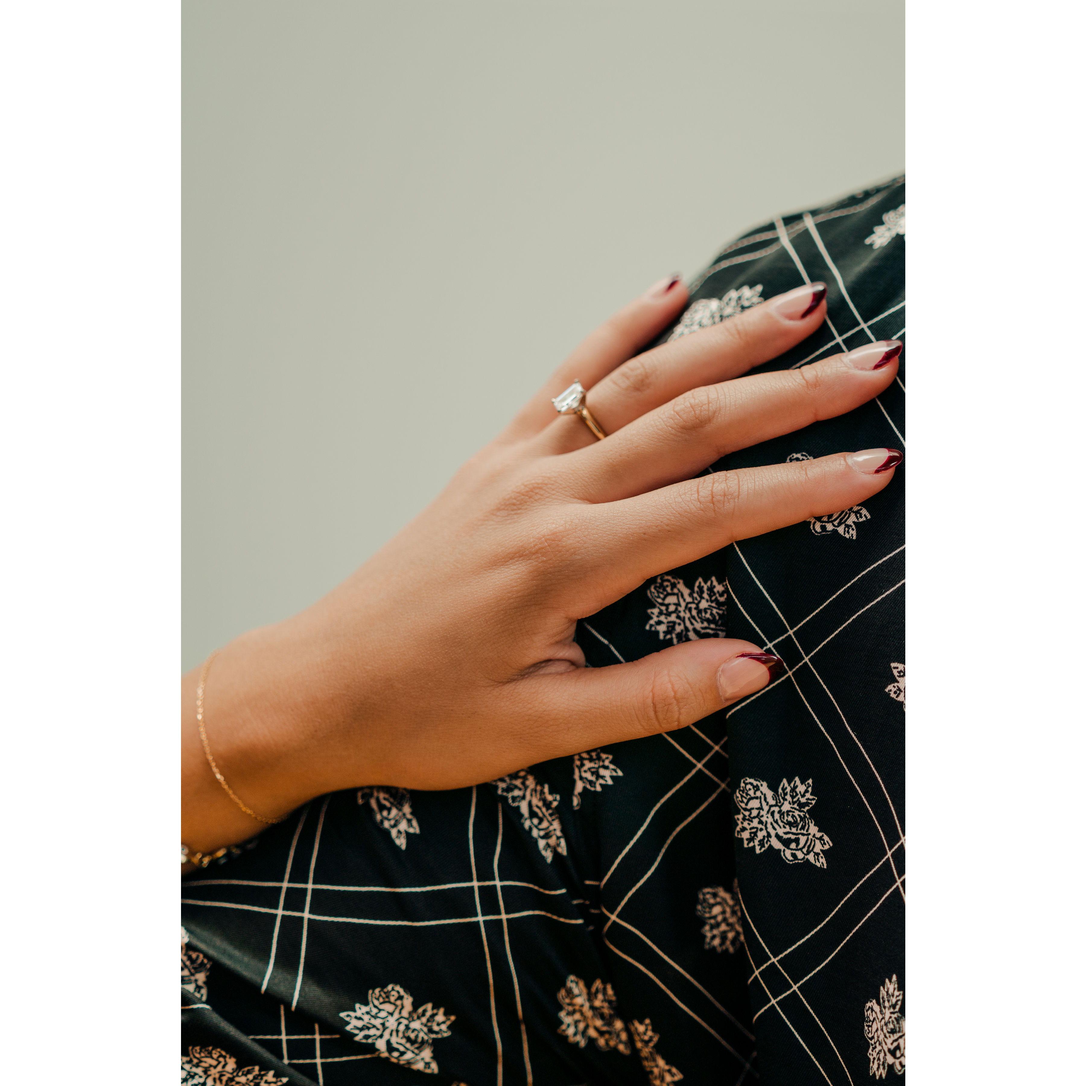 Destiny's hand with engagement ring on Kieran's shoulder