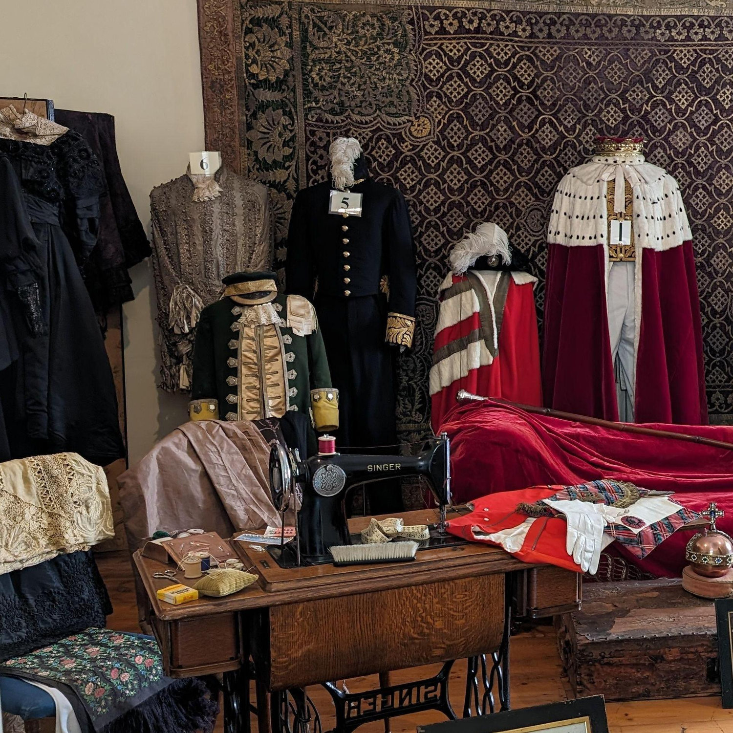 More boys' outfits and one girl's black dress in the Seamstress's Room of Dunrobin Castle.