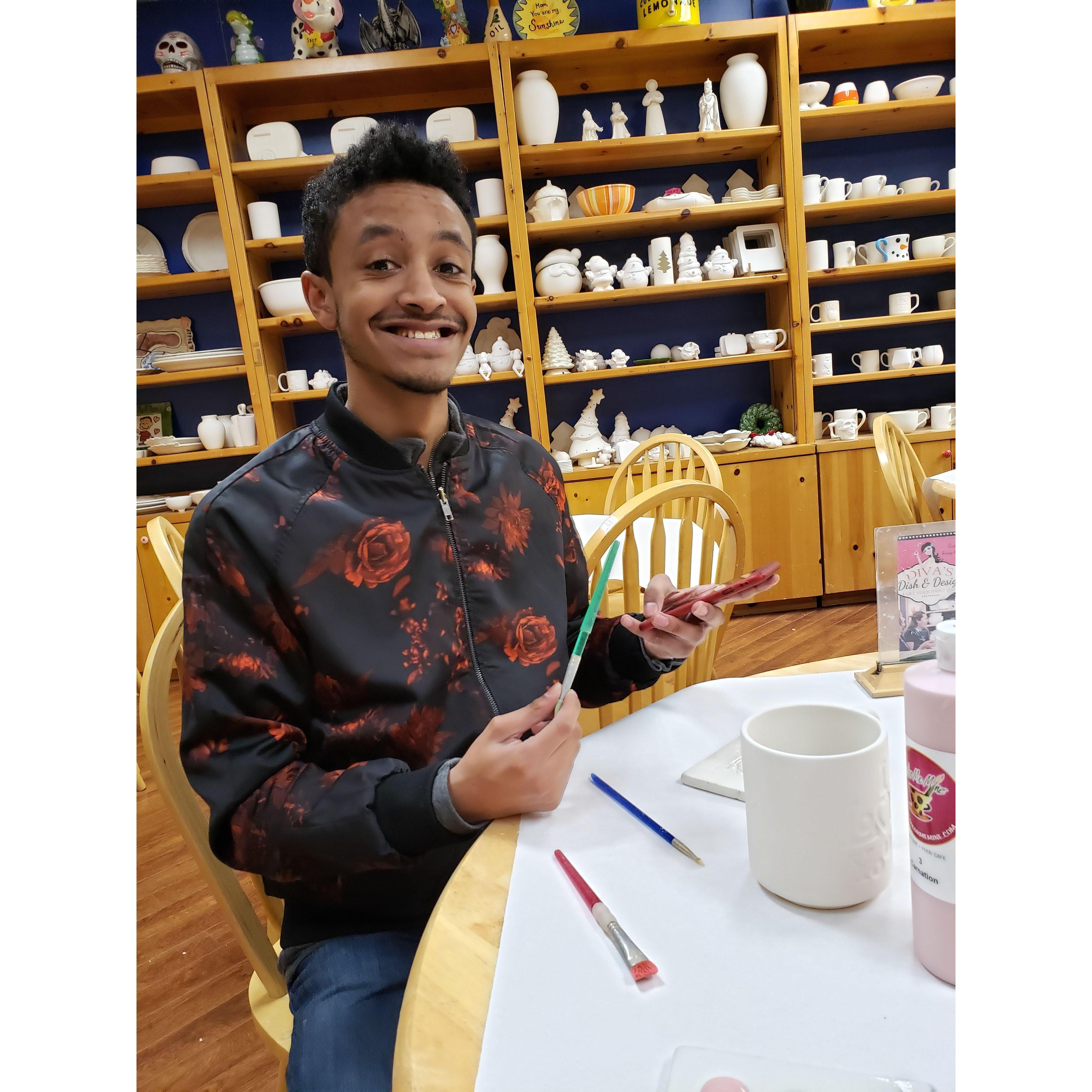 He was excited to paint that mug in front of him. This was at "Color Me Mine"!
