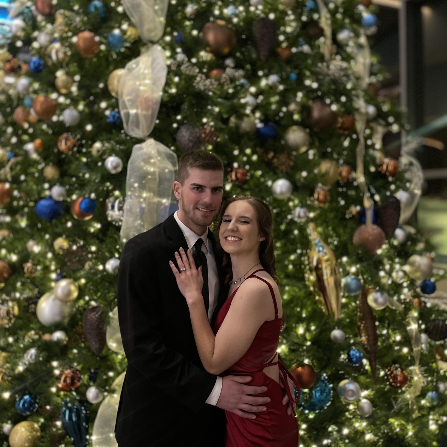 being cute by a christmas tree