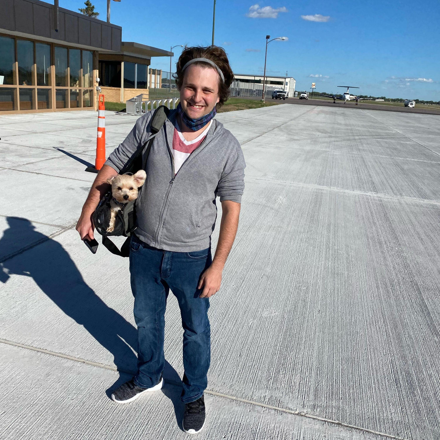 The adventures continue as Shane and Pebbles stand on the runway of Watertown Regional Airport.