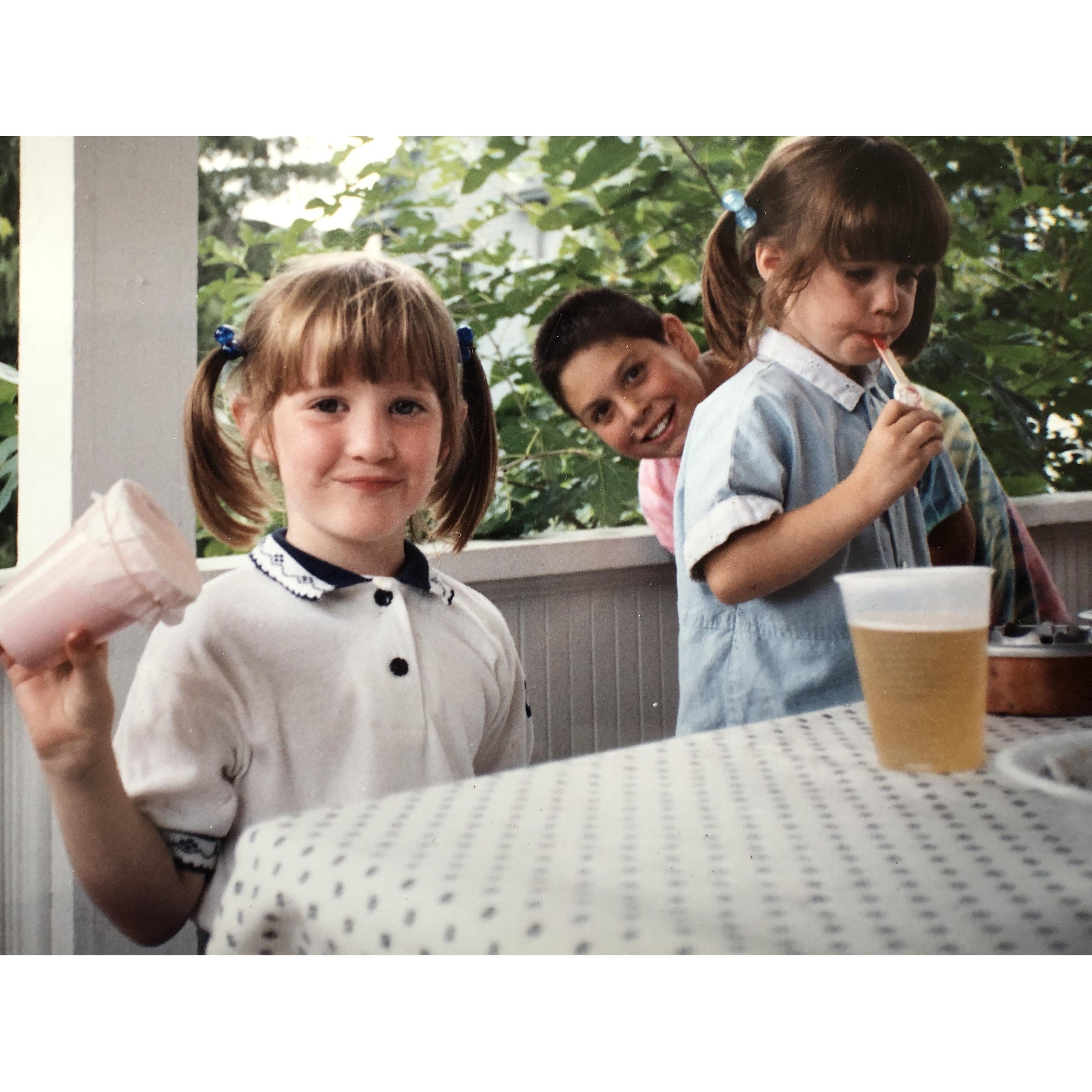 Cute in pigtails, not sure who that kid in back of us is. And who left a full beer in front of us?