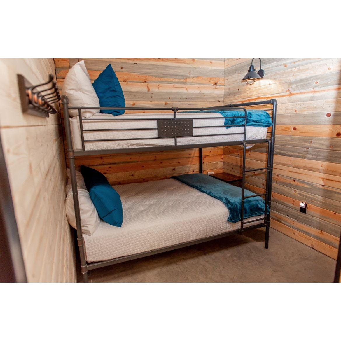 "Patch" Room. Has a queen bunkbed & is the most private of all the bunk-stalls because the top is mostly enclosed & it’s the furthest stall down the hallway. Sleeps 4.