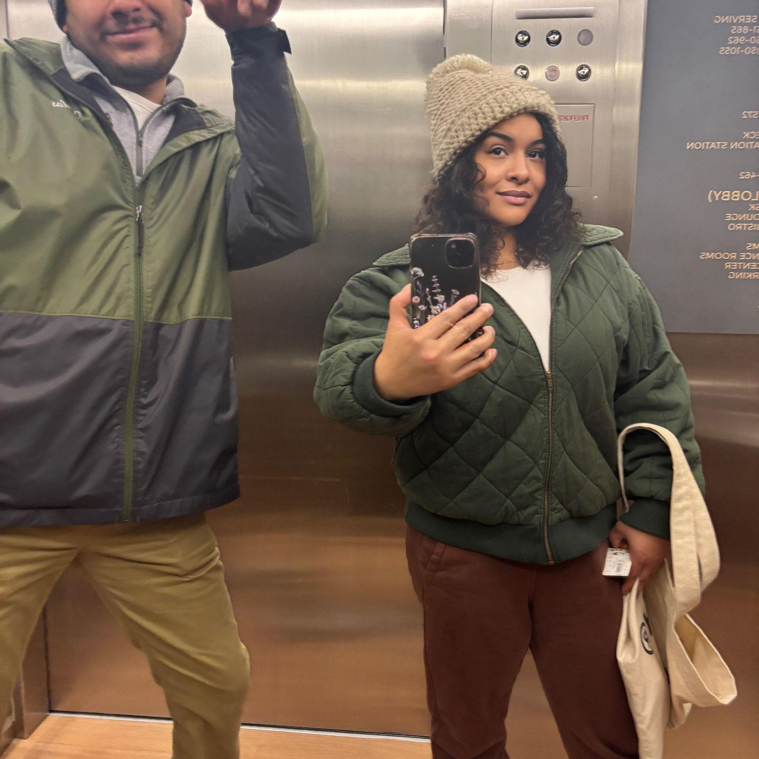Elevator moment after a day on the slopes—snowy hair, tired legs, and Colorado flurries still falling outside.