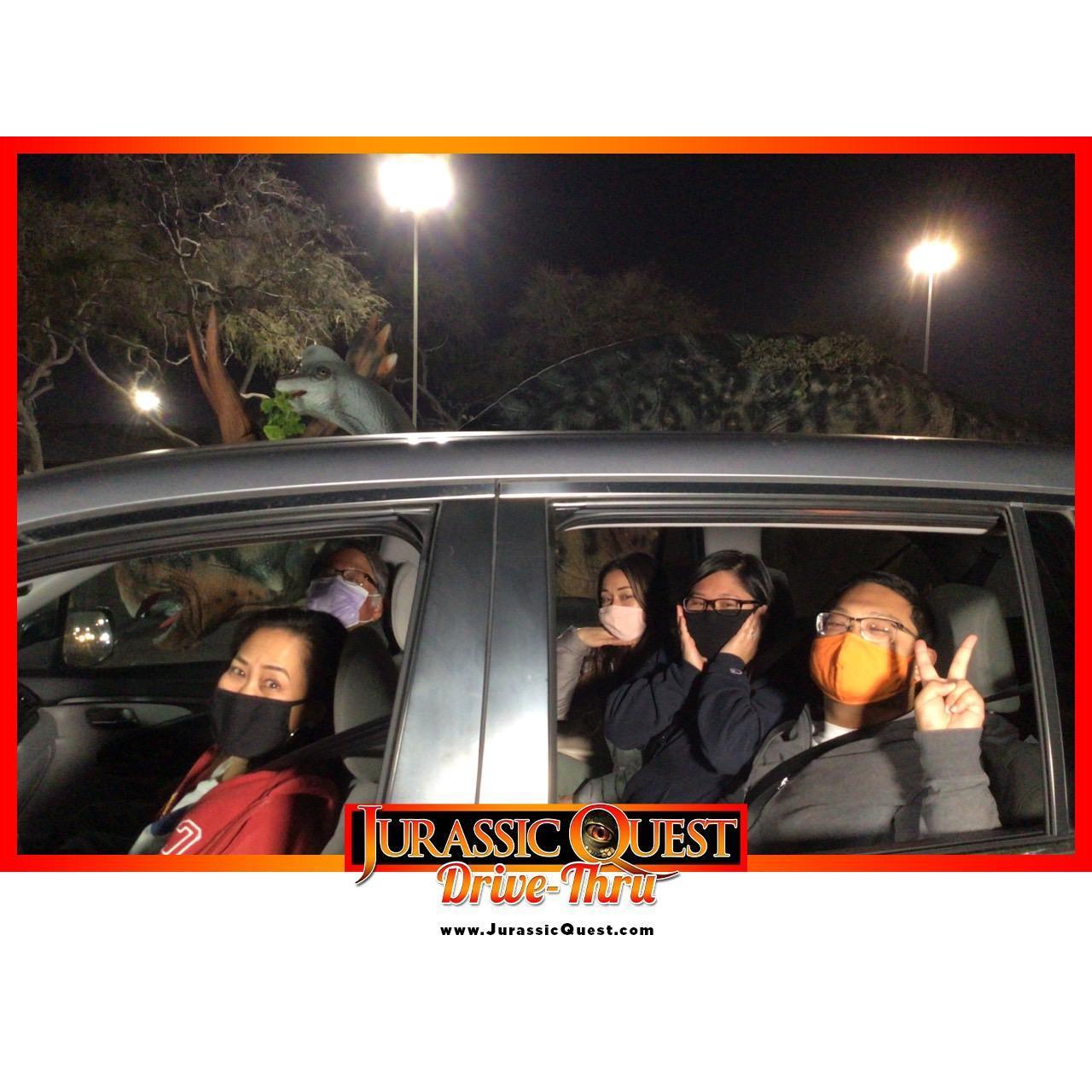 Kelly, Stan, Jan, Kalia, and Melia posing for a Jurassic Quest drive-through adventure during COVID