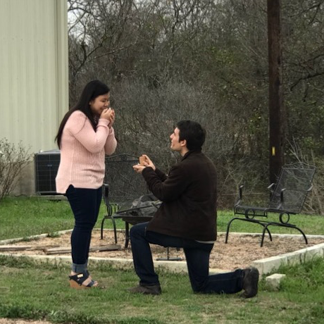 Liana giggling with joy (and surprise) as Bruno is proposing on one knee