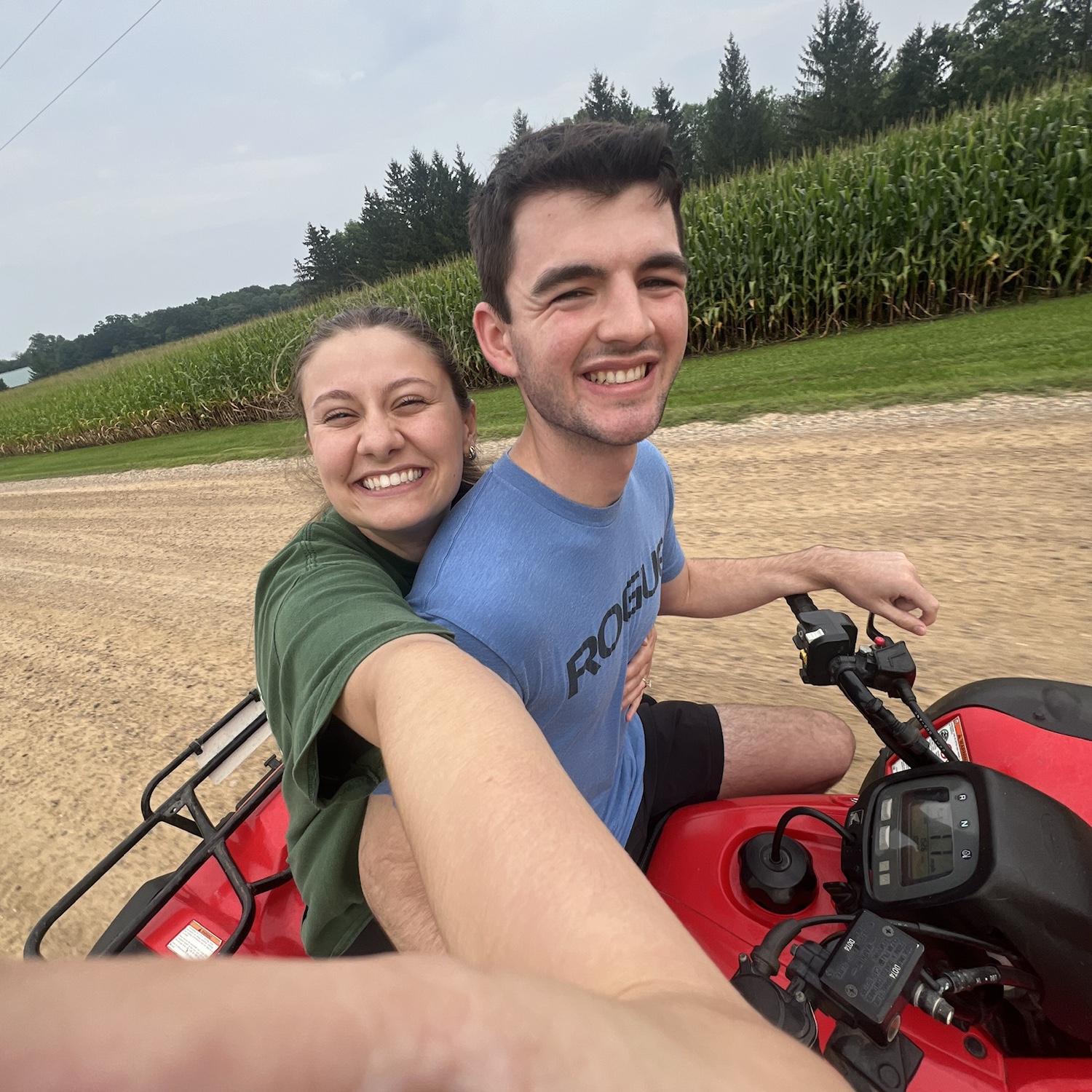 Emma and Logan in Minnesota riding the four wheeler down dirt paths & corn fields!