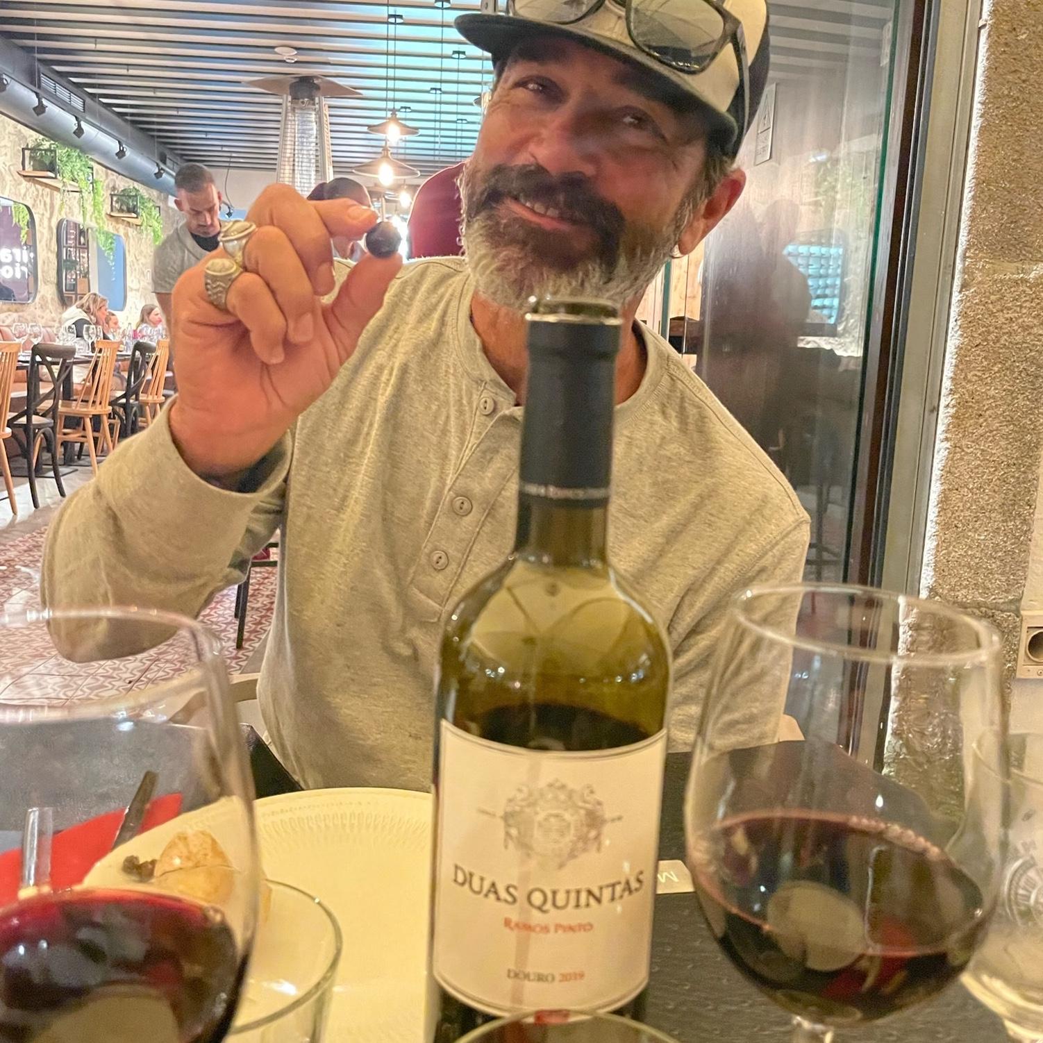 Johnny enjoying his favorite, olives, in Porto.