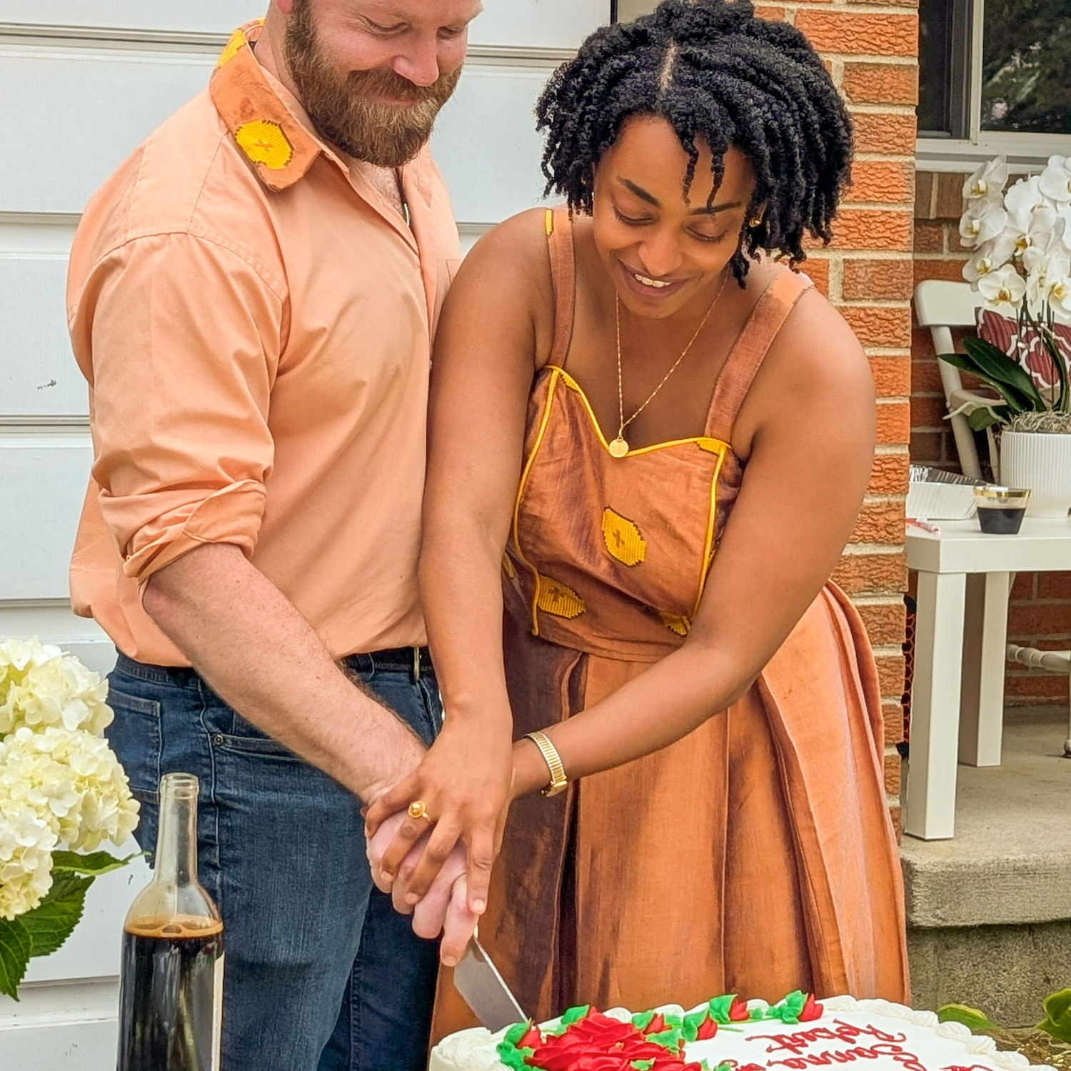 Sana and Robert cutting the cake at the Ohio Engagement Party.